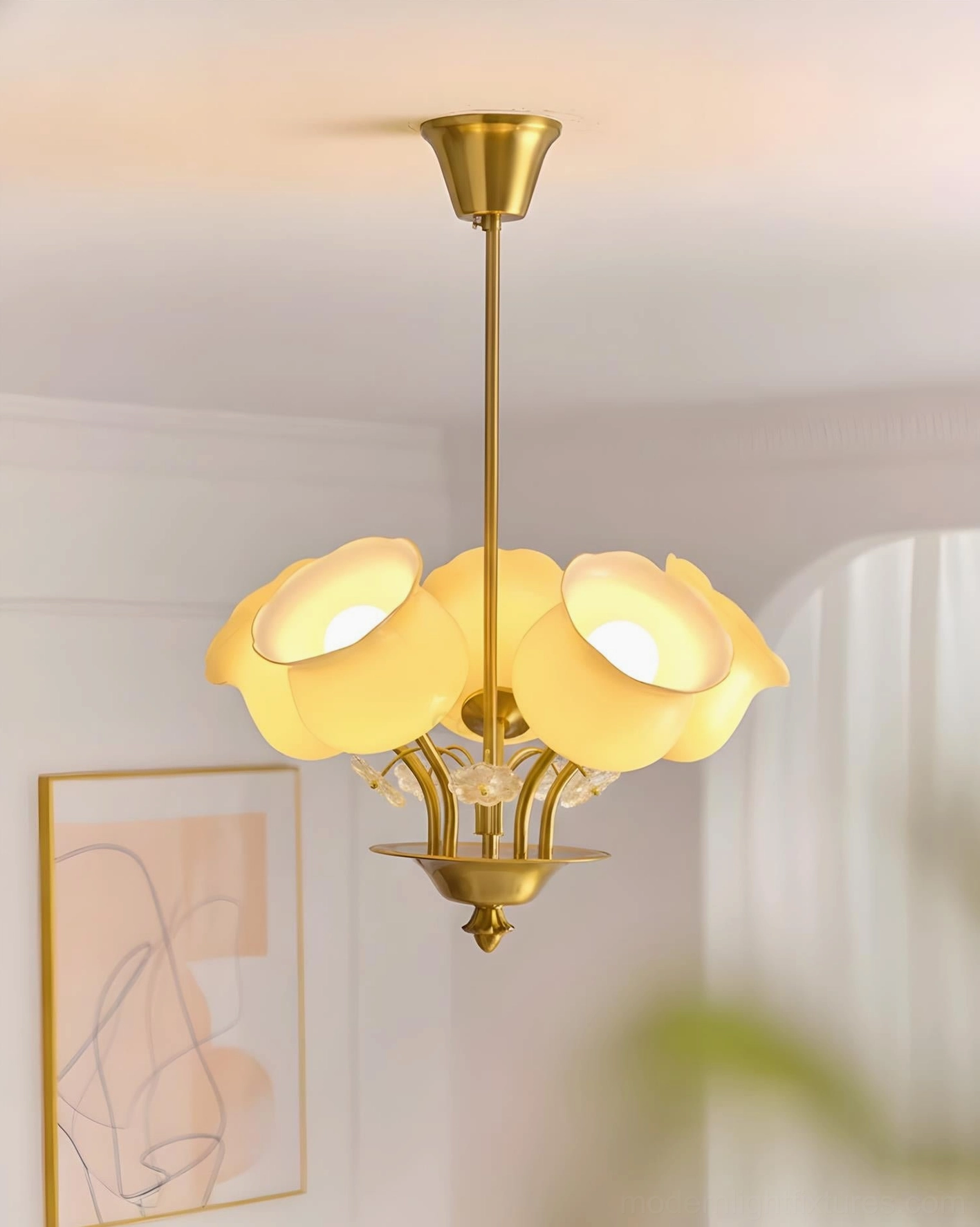 Solenne Petal Chandelier illuminated overhead view in minimalist French room with modern wall art and accessories