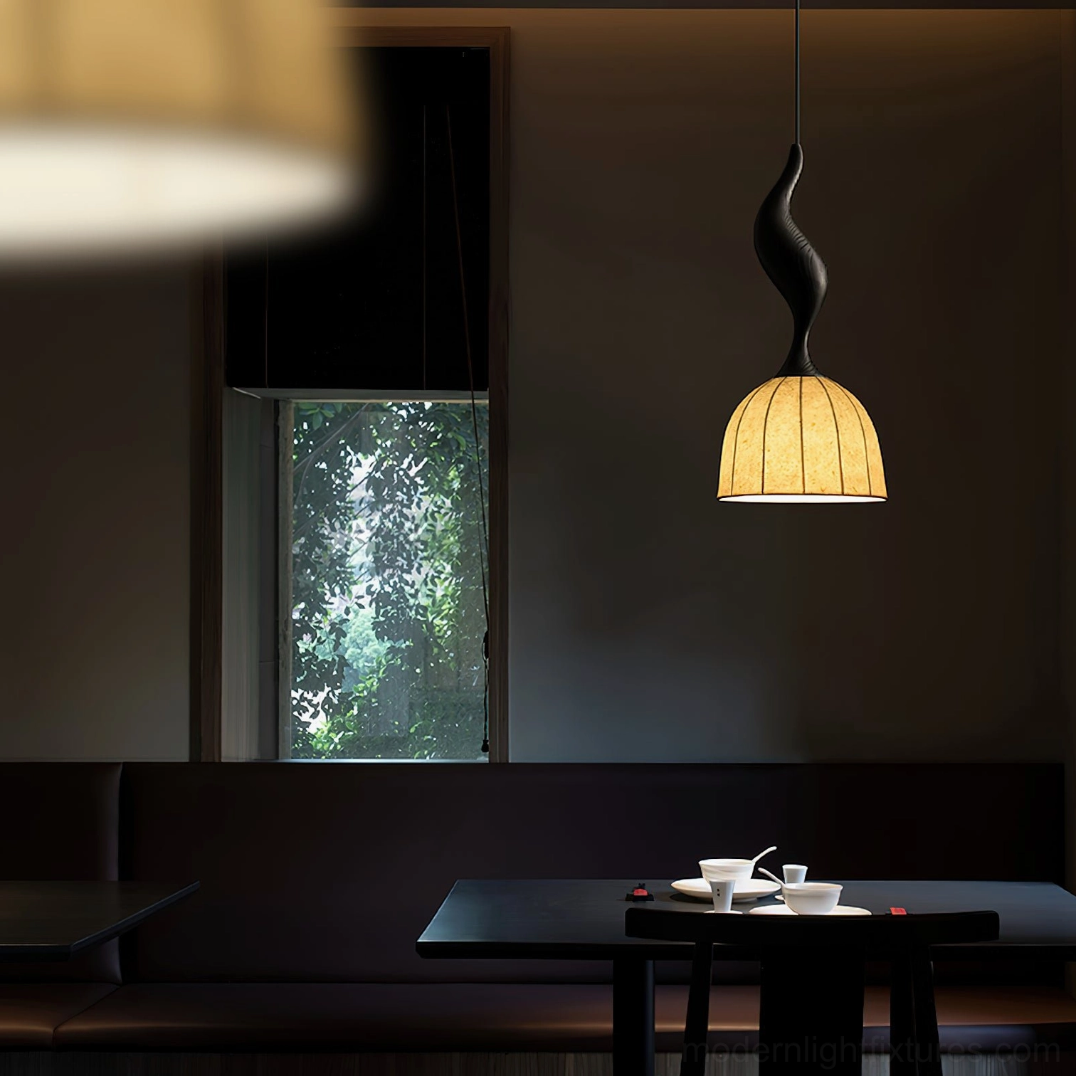 Single black wood Solia pendant lamp with beige fabric shade, restaurant dining booth ambiance