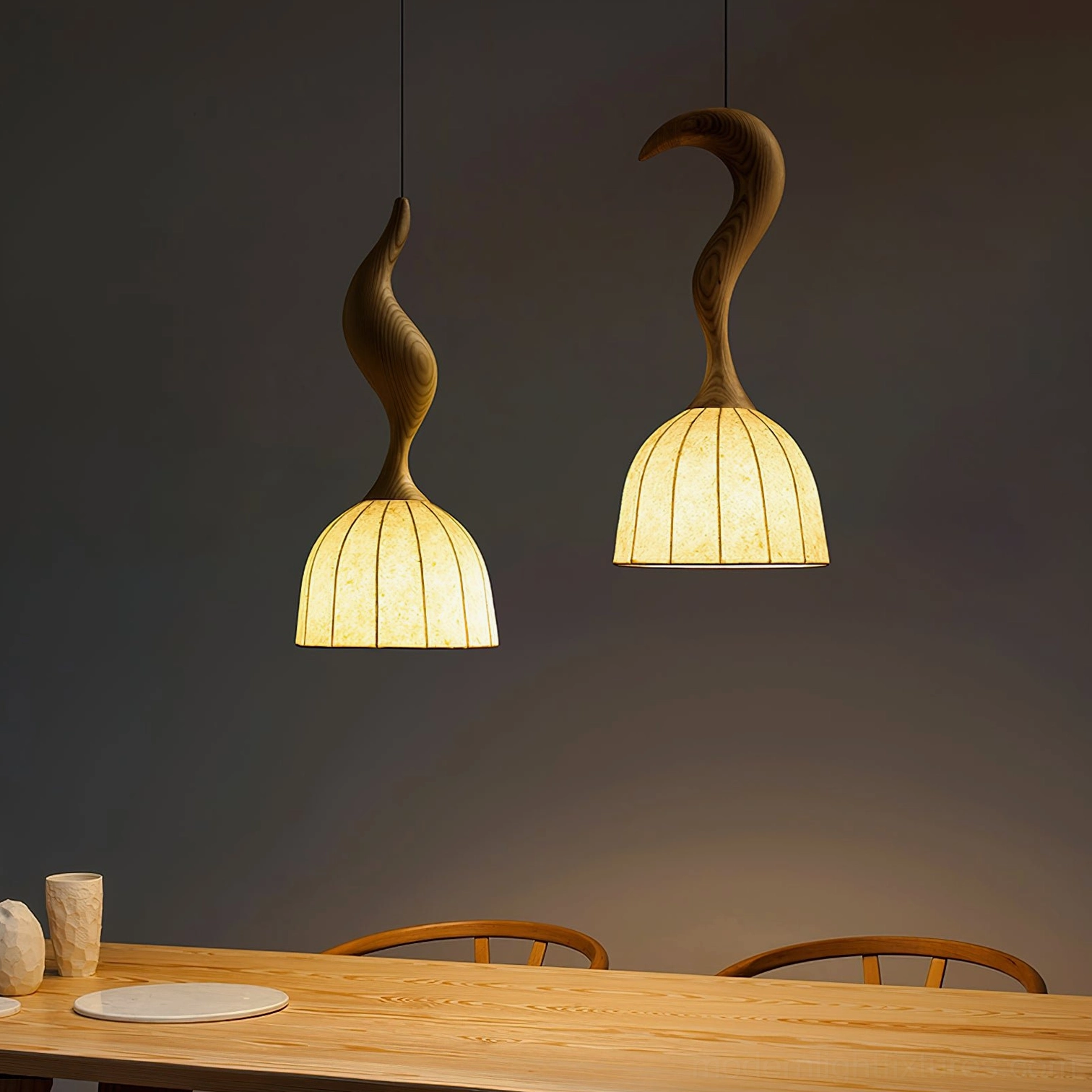 Dual Solia wooden pendant lights hanging above dining table, warm ambient lighting in home interior
