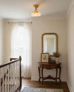 Soliloquy vintage semi-flush ceiling lamp installed in residential hallway with brass-gold fixture and hand-detailed floral glass shade