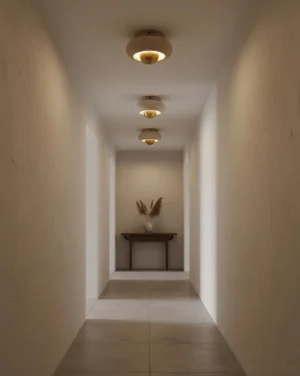 Modern travertine ceiling light fixtures installed in residential hallway with warm ambient lighting