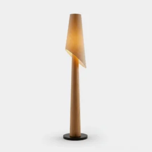 Solstice Flow asymmetrical floor lamp with black fabric shade and light wood pole, studio view