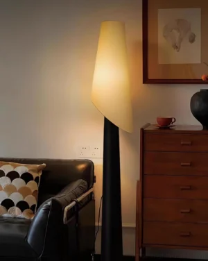 Modern asymmetrical floor lamp in living room setting with mid-century furniture and wooden cabinet