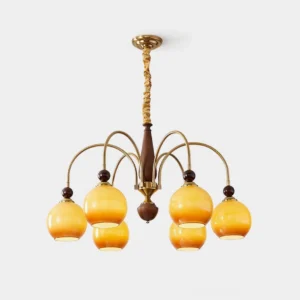Solstice Glow 8-head brass chandelier with amber glass shades and wood accents on white background, front view