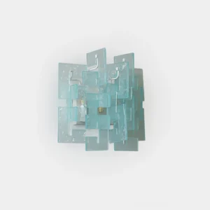 Solvante geometric glass wall sconce with cyan frosted glass blocks stacked in modern sculptural design, front studio view