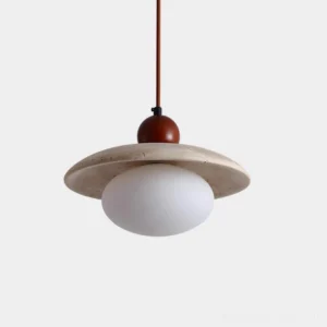 Solven modern pendant light with frosted glass globe and travertine disc - front studio view
