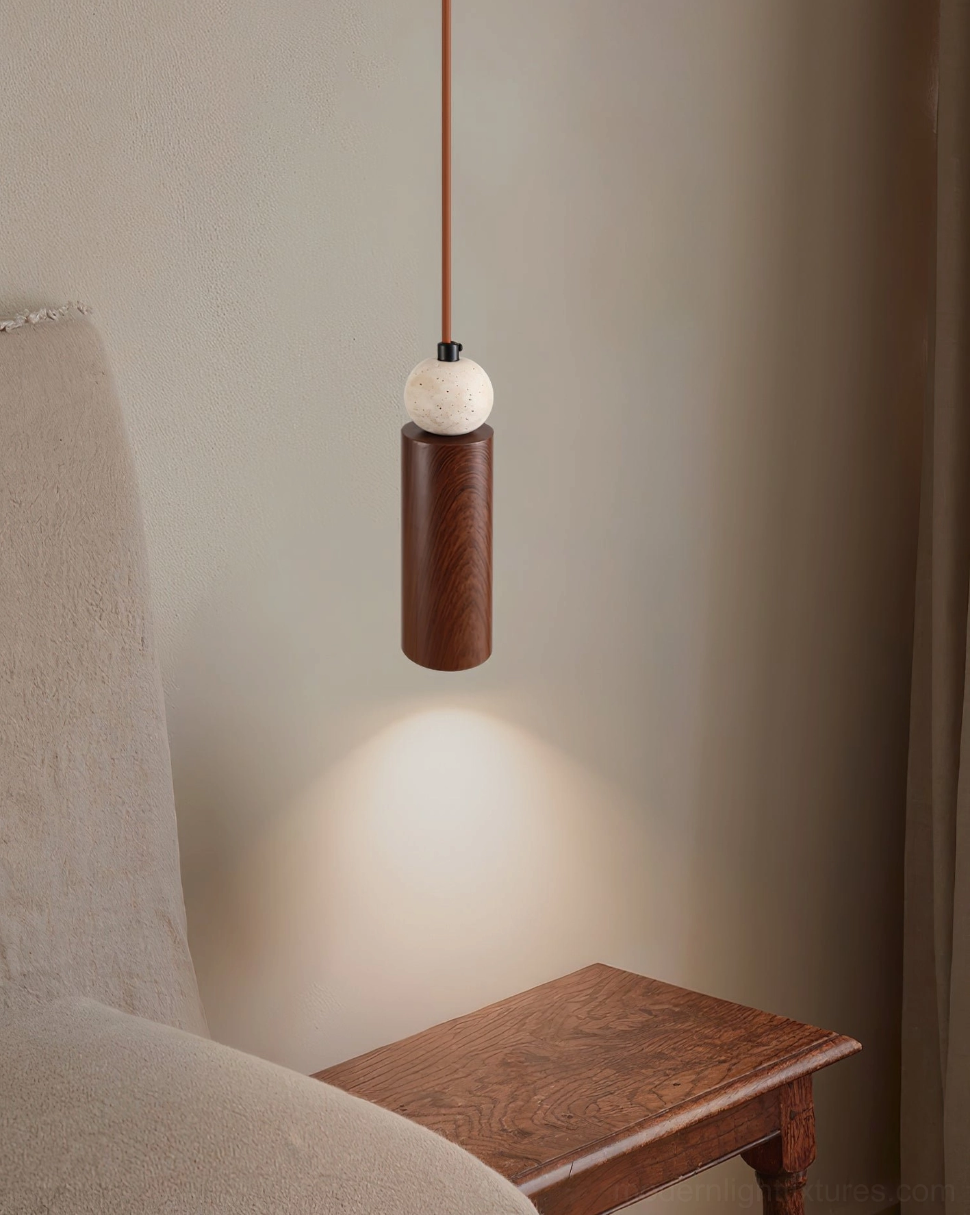 Somira contemporary hanging lamp showing warm metal finish and natural stone sphere design aesthetic detail
