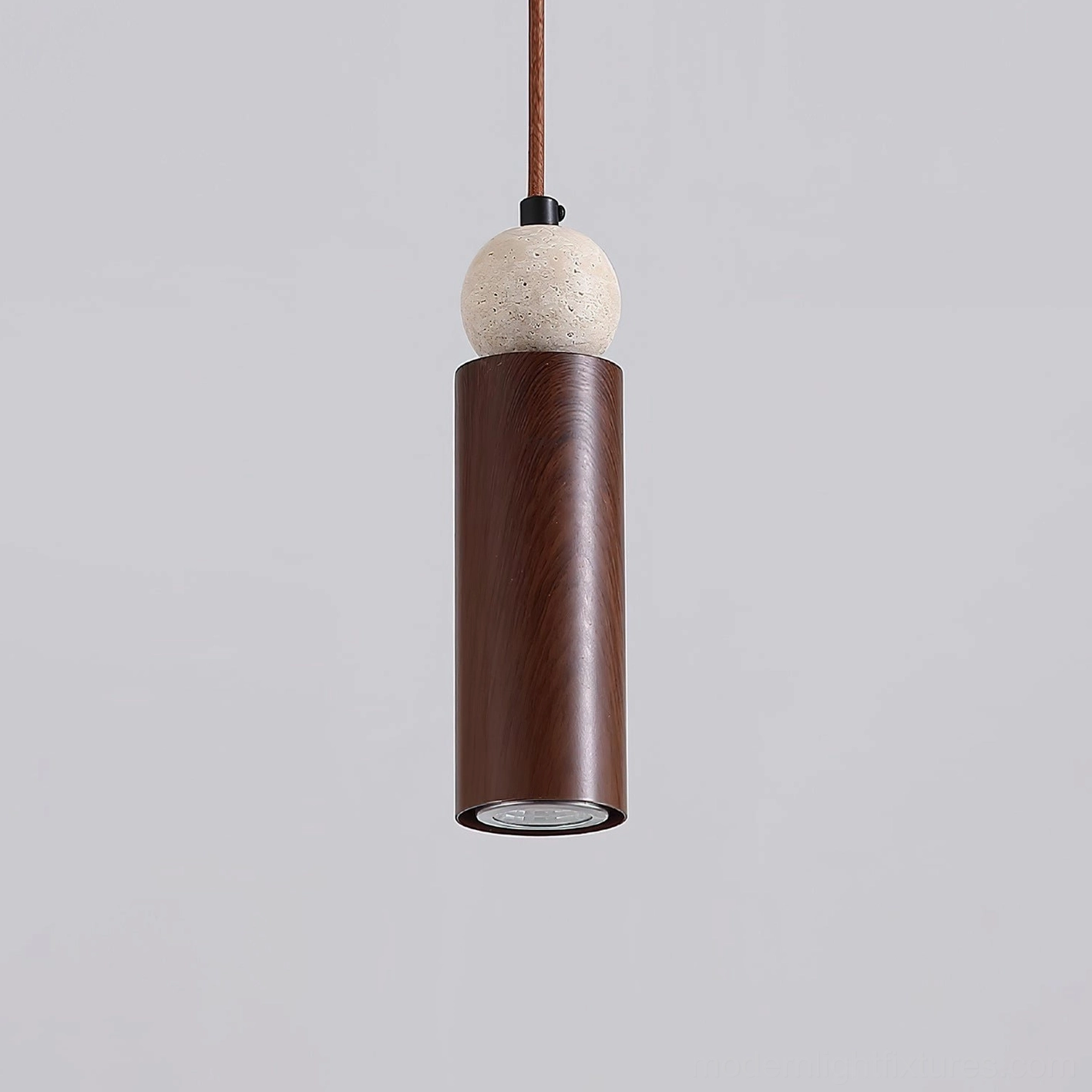 Somira contemporary pendant fixture showing artistic play of light and shadow through geometric metal design