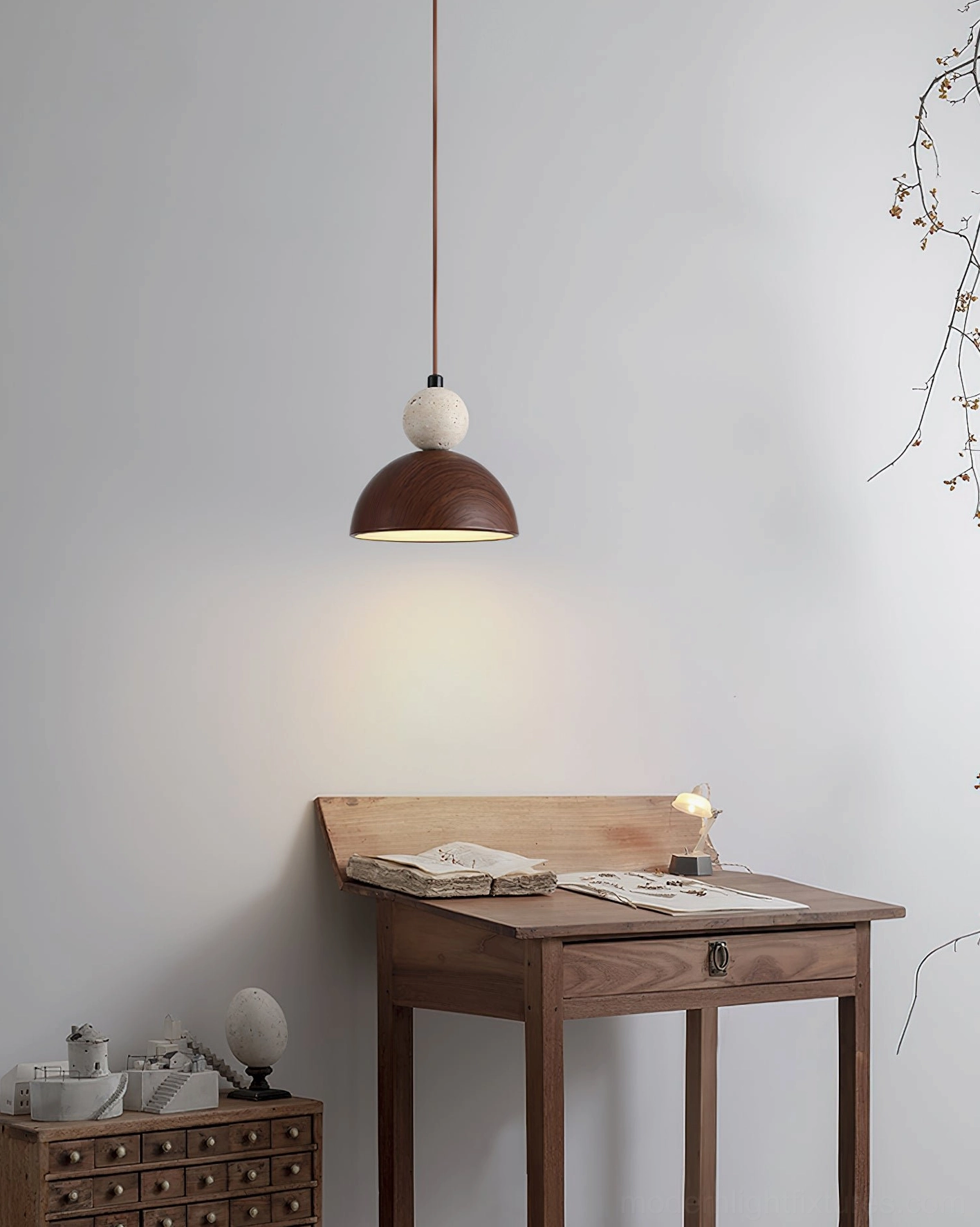 Somira contemporary pendant light installed above vintage study desk, warm ambient lighting in wabi-sabi interior design