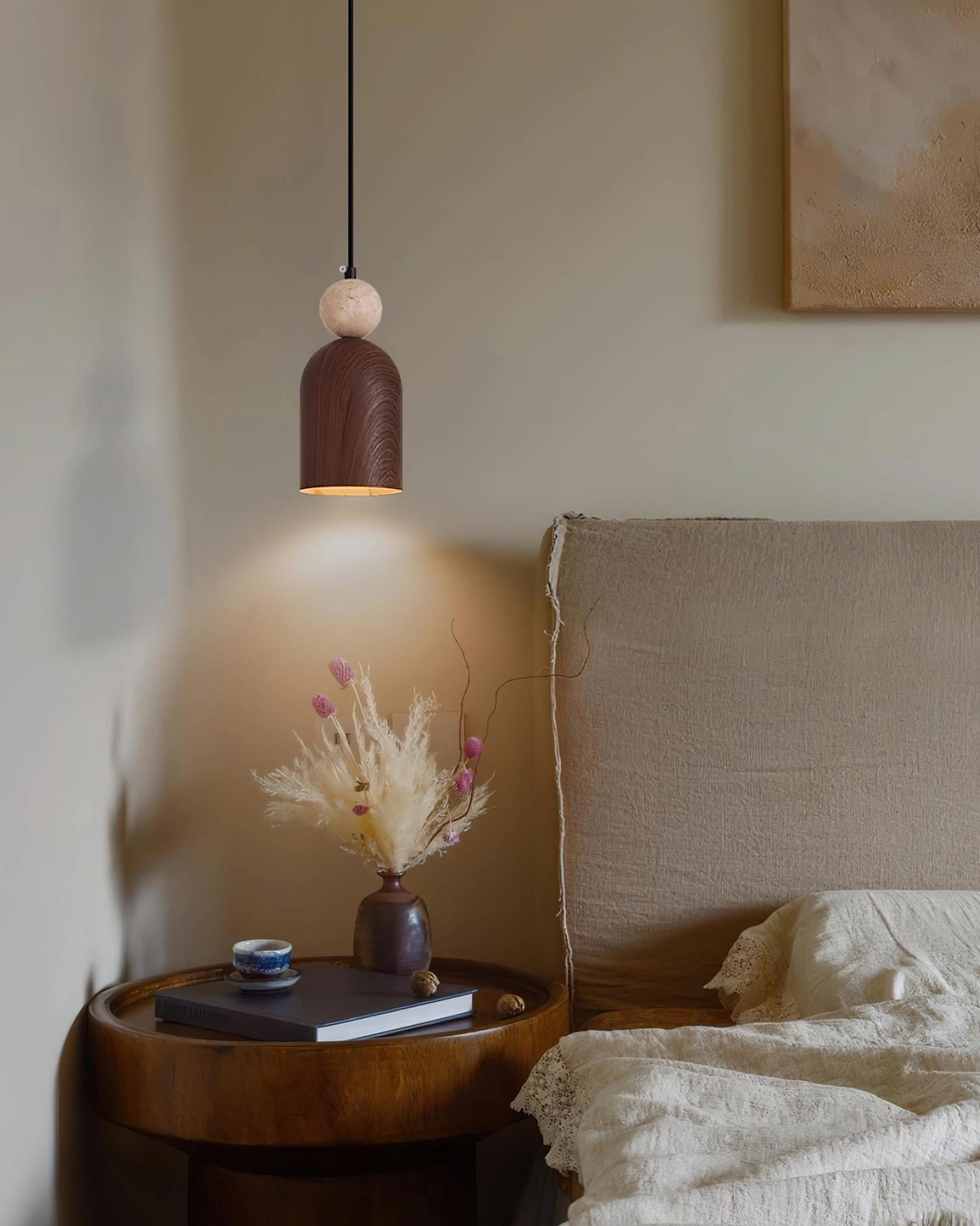 Somira modern pendant light showing metal shade construction and travertine sphere positioning in detail view