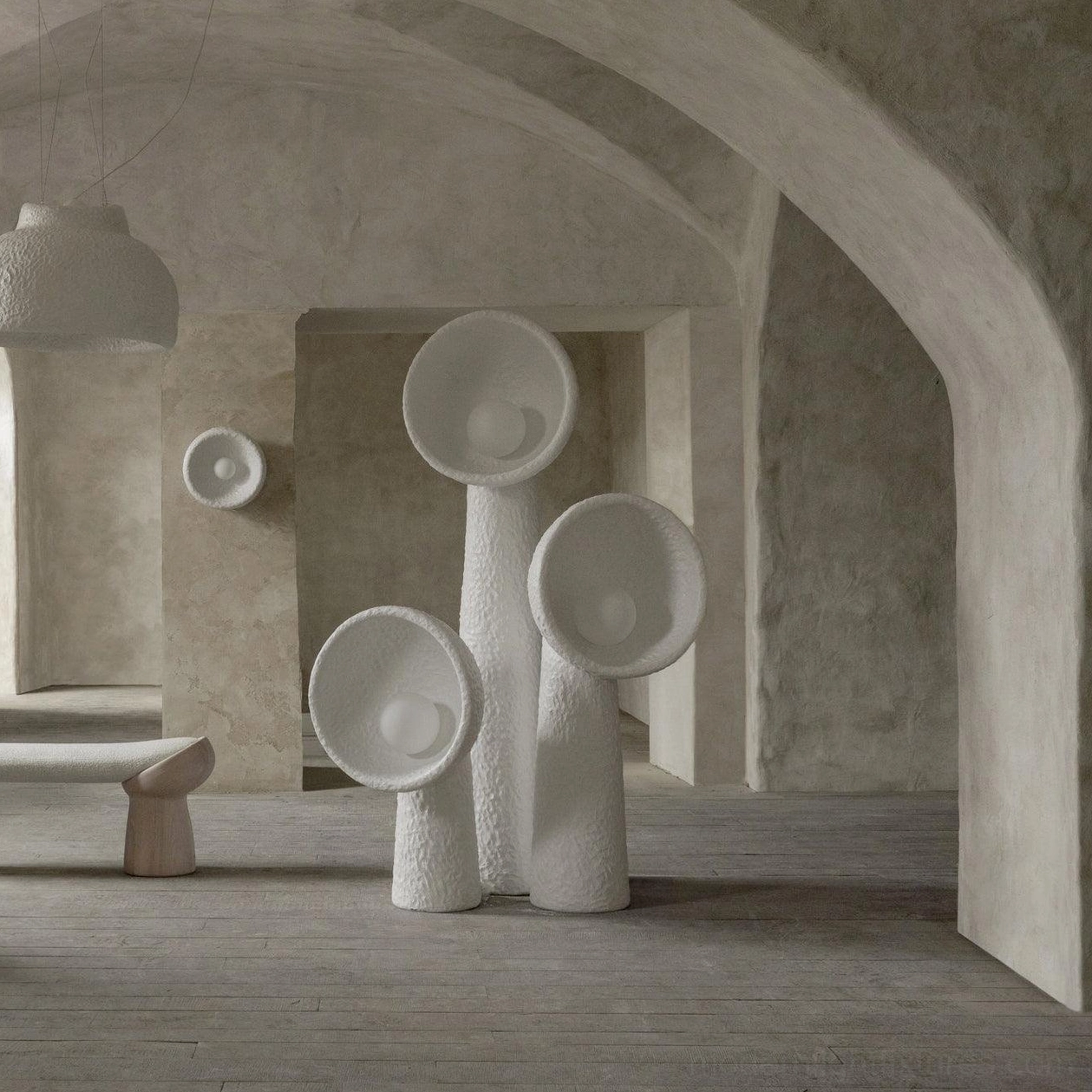 Collection of Soniah white sculptural lamps floor and wall mounted minimalist exhibition space