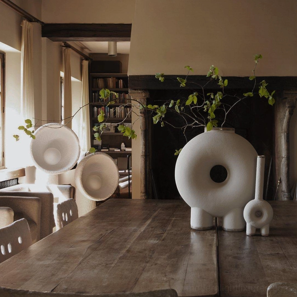 Soniah white matte resin lamps in rustic dining room with fireplace warm ambient lighting