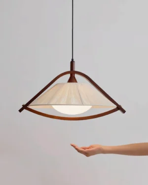 Sonoma wood pendant light with scale reference, hand held against warm frosted diffuser