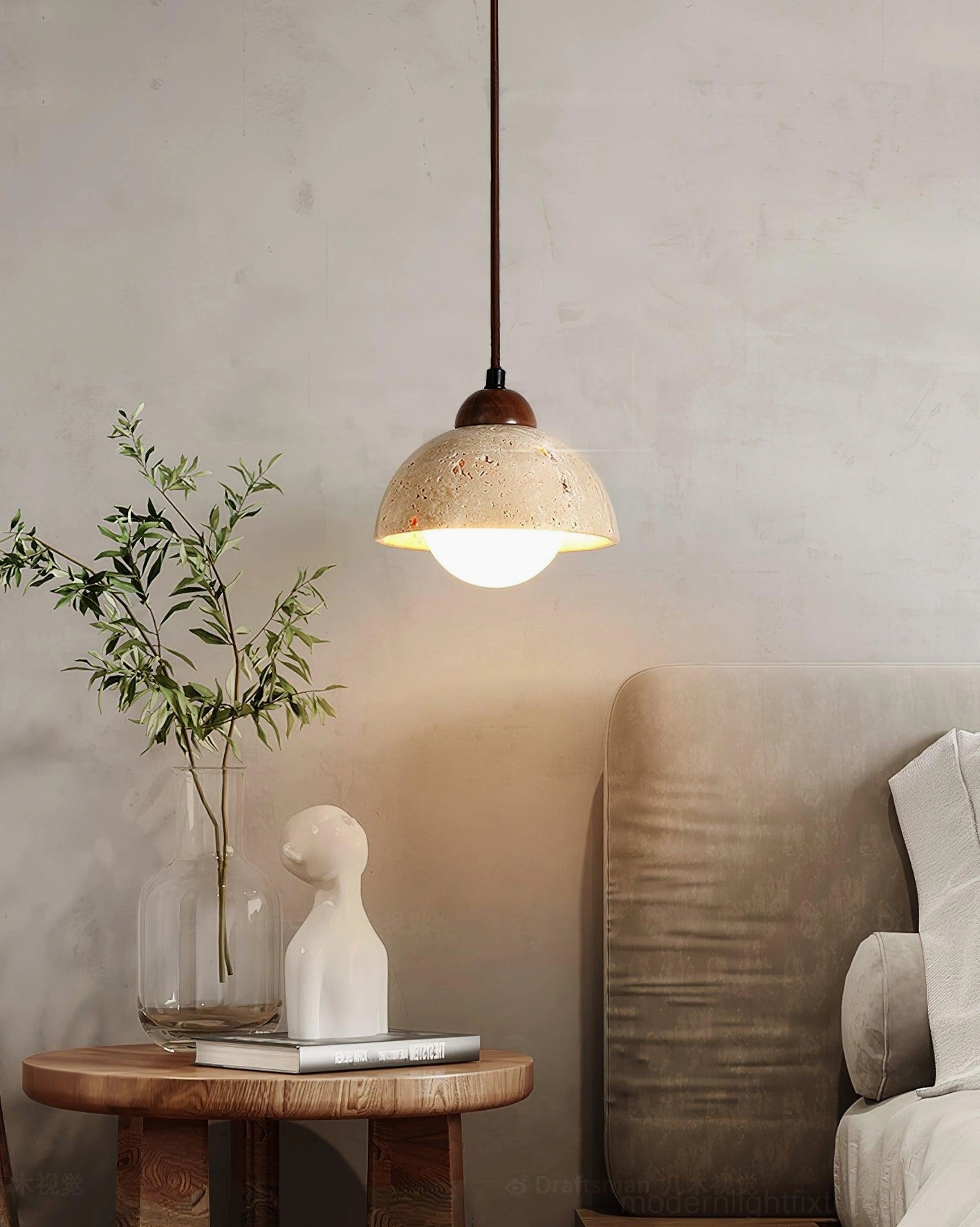 Soren travertine pendant light above small side table with green potted plant warm natural decor