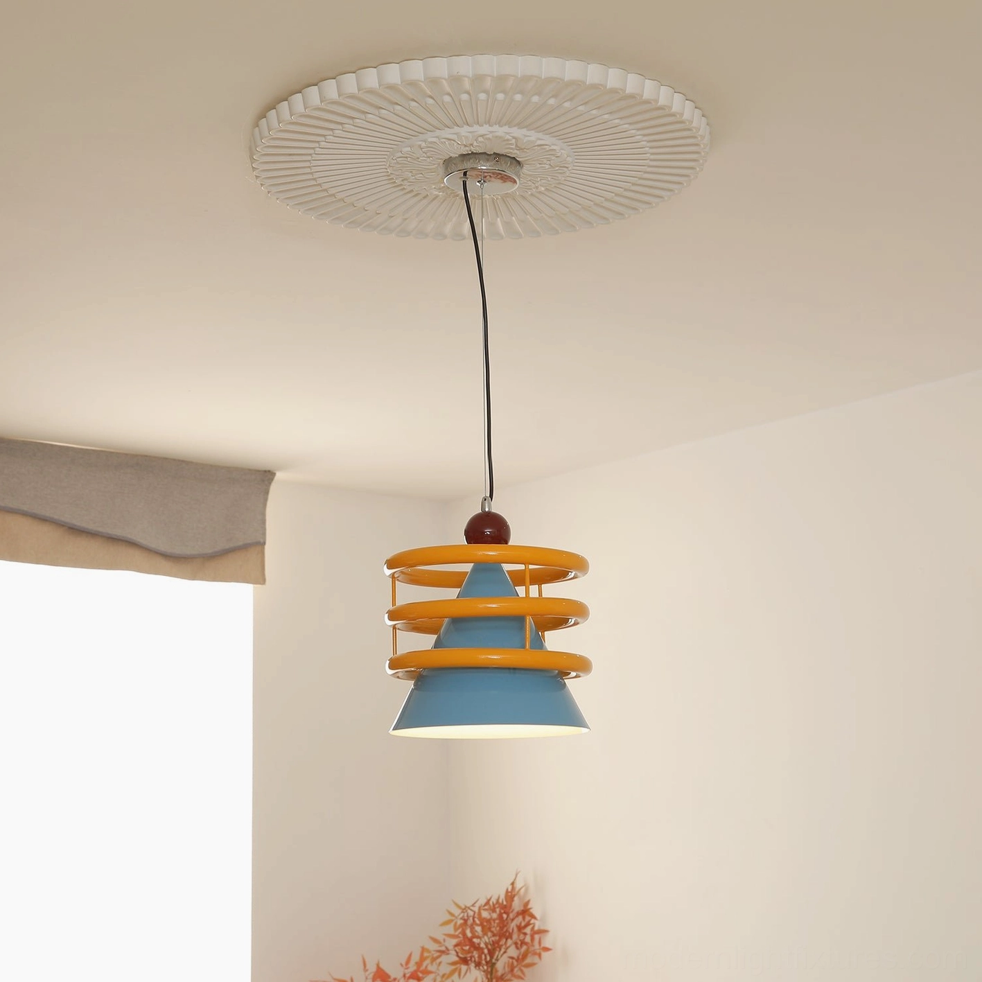 Sowden geometric pendant lamp glowing in residential corner with embossed ceiling rose, artistic metal design detail