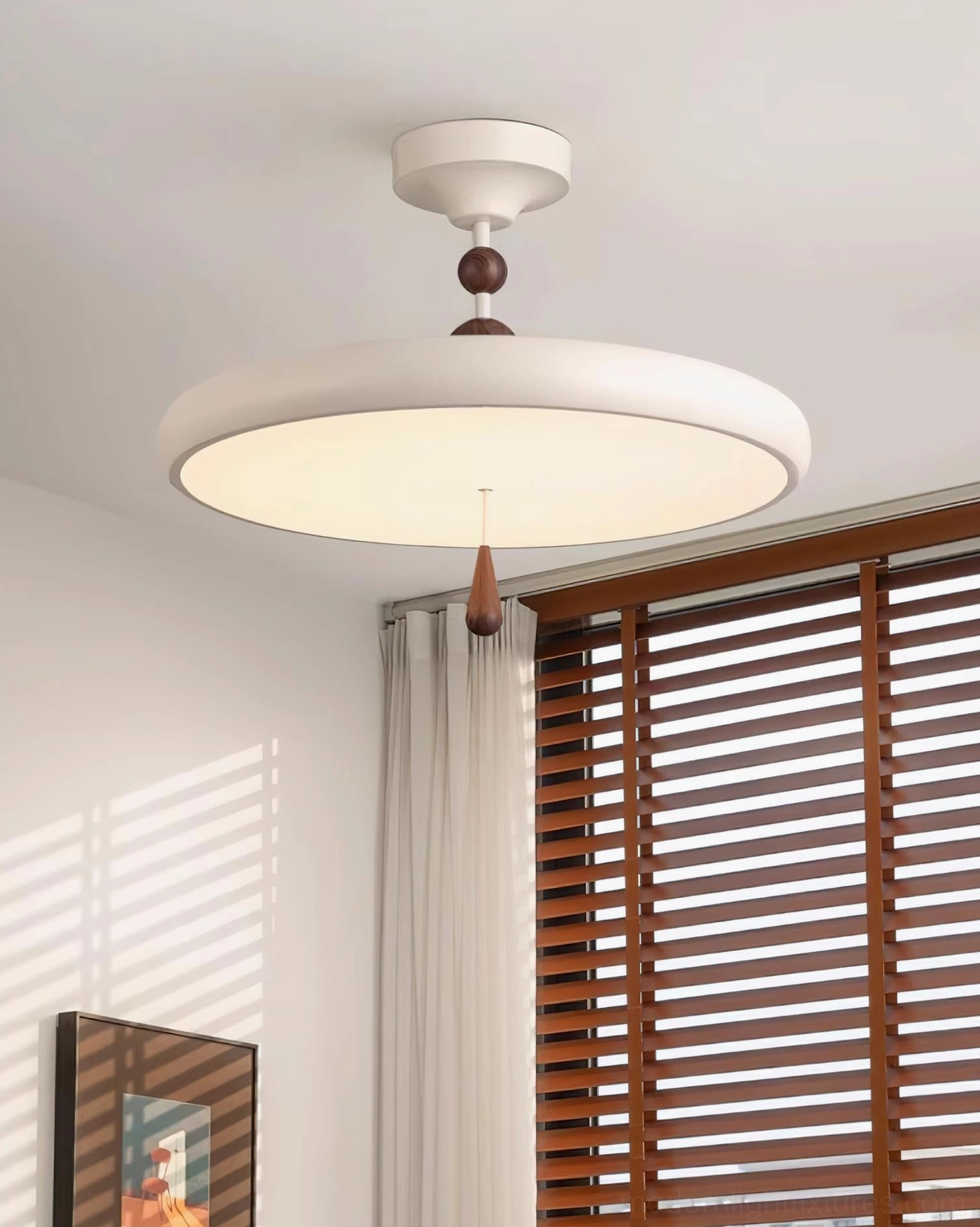 Side overhead view of illuminated Spectrum Ring ceiling light fixture with wooden blinds backdrop