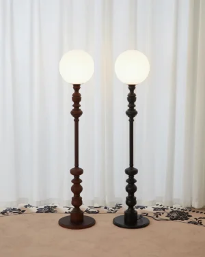 Two Sphereline floor lamps in different colors displayed in contemporary living room with neutral decor