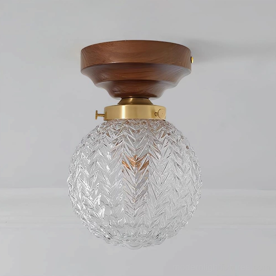 Flush mount ceiling light with spherical textured glass shade and wooden canopy, hallway installation view
