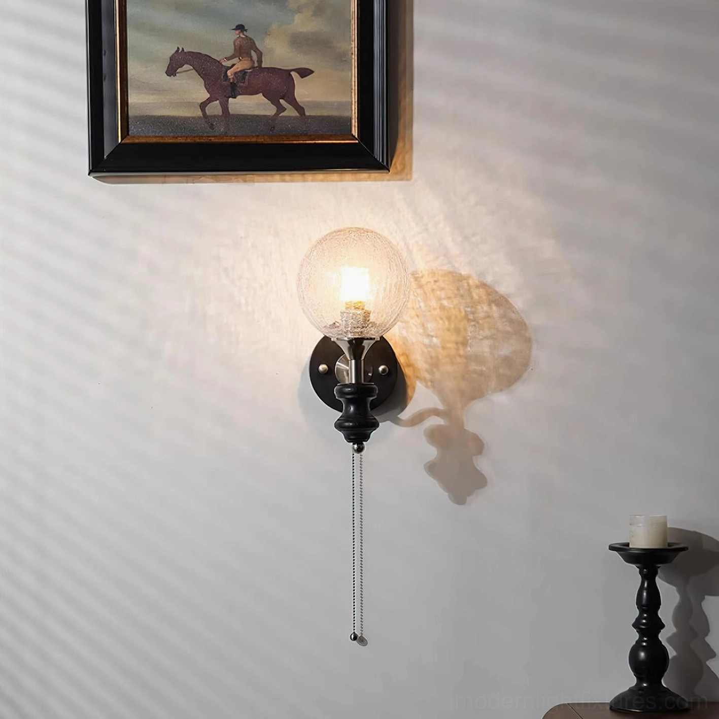 Spherical wall sconce detail shot showing frosted glass texture and pull-chain mechanism