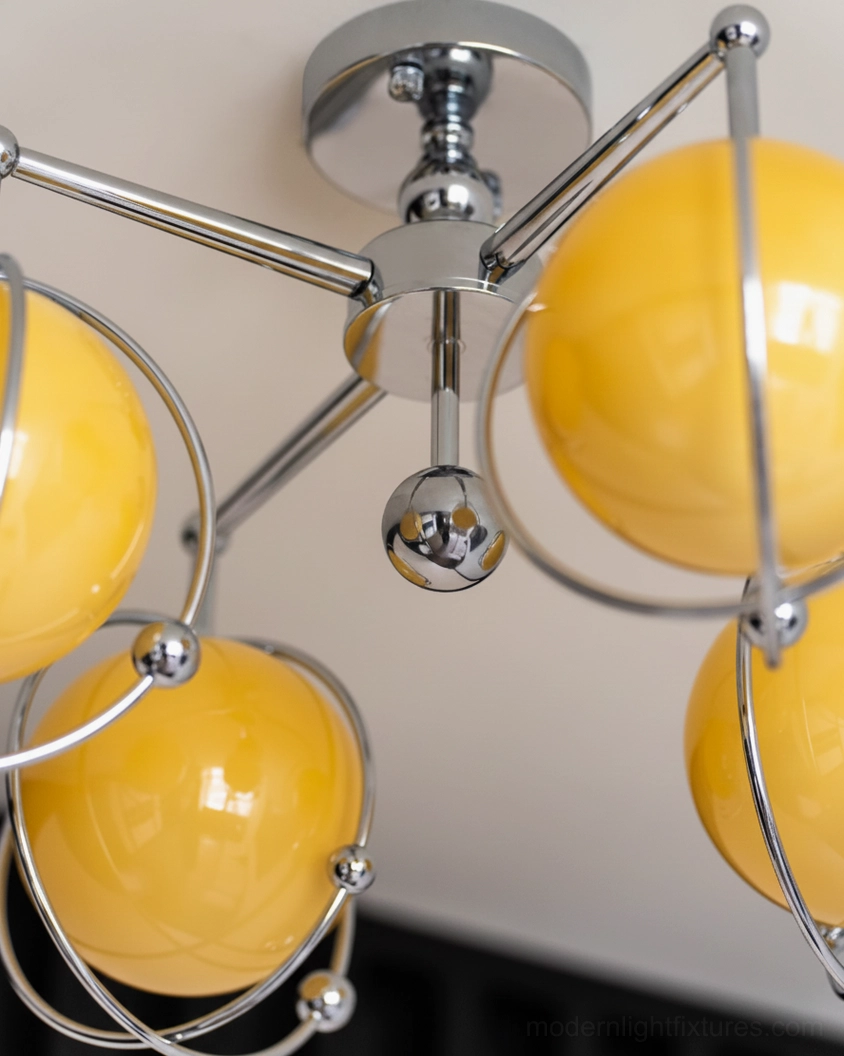Modern ceiling light fixture with spinning globe design and contemporary chrome hardware