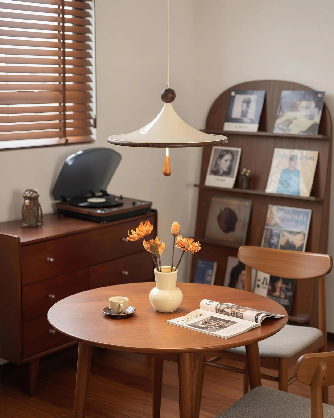 Spinora modern pendant light in dining area with record player shelf, three-quarter angle view demonstrating sculptural form