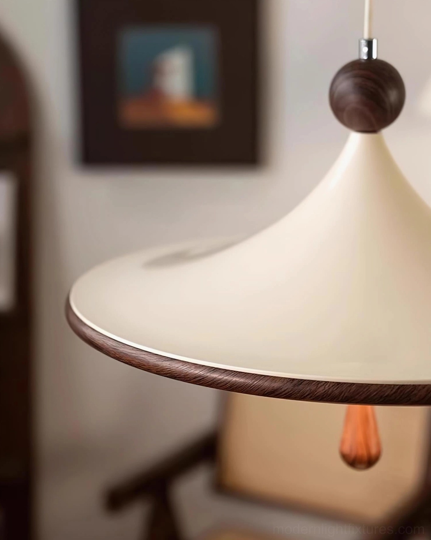 Close-up detail of Spinora pendant light finial, acrylic shade, and teardrop ornament showing sculptural craftsmanship