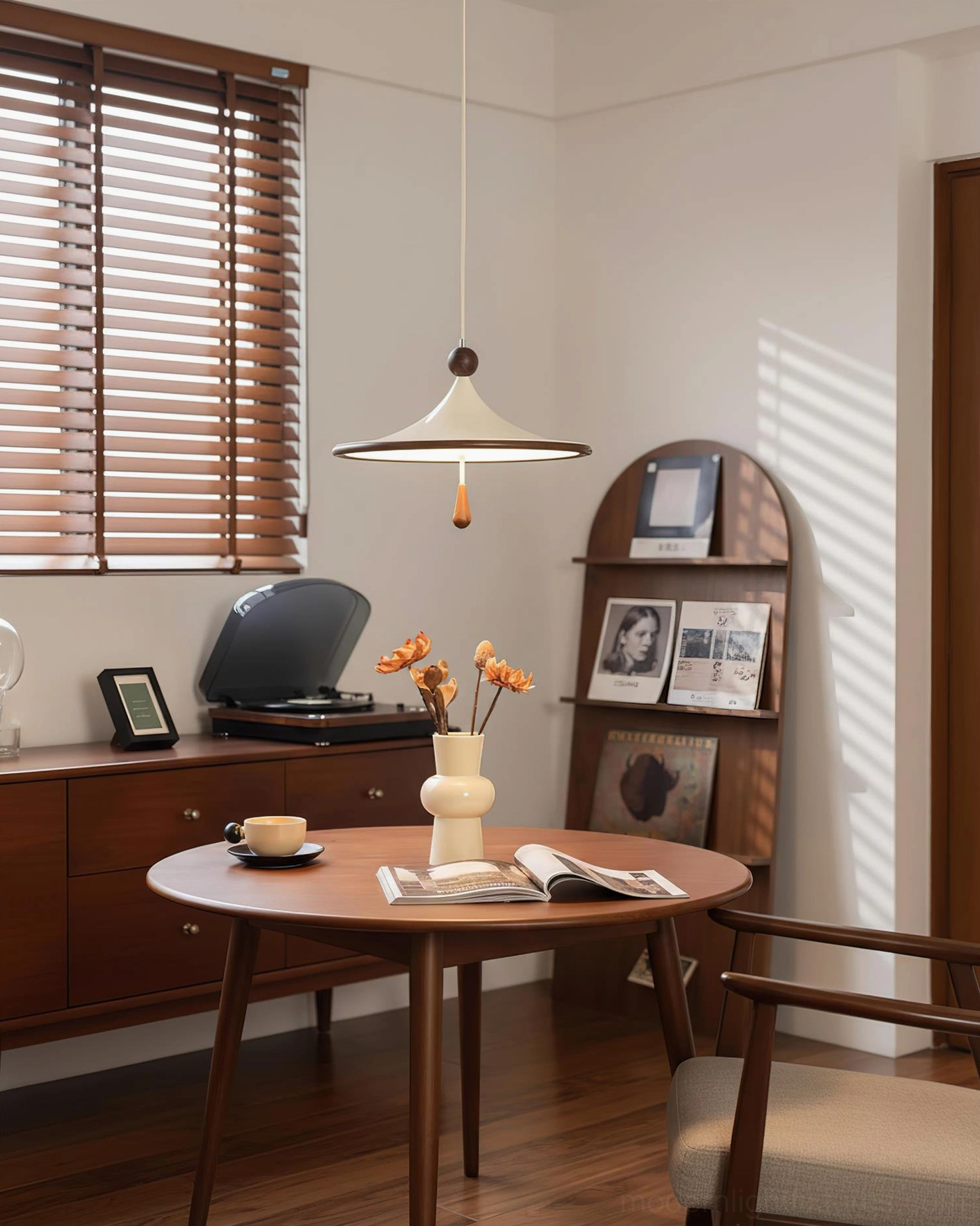 Side view of Spinora pendant light showing acrylic shade profile and delicate drop-shaped finial, retro dining space setting