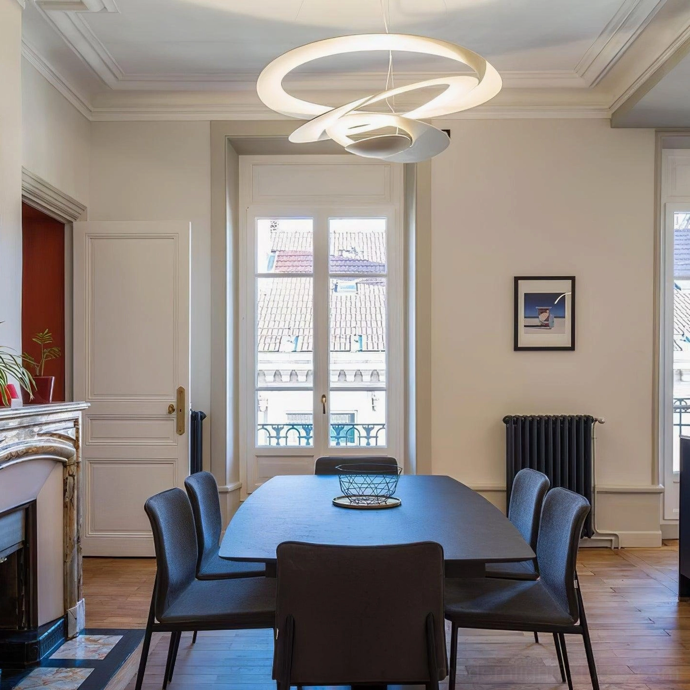 Spiral LED chandelier architectural detail, twisted ring structure creating light and shadow patterns