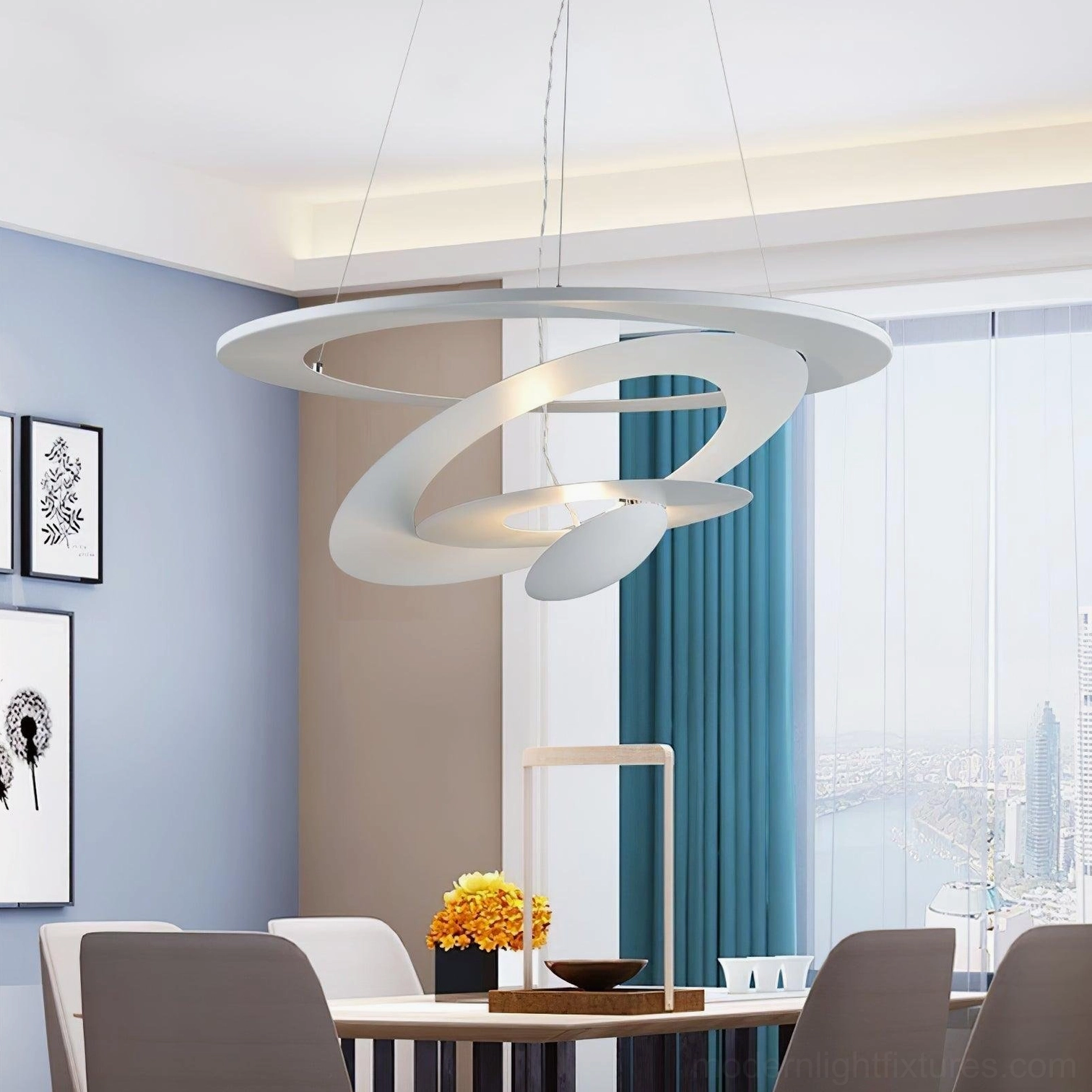 Contemporary spiral pendant light in dining room with warm LED illumination, layered circular design against blue walls