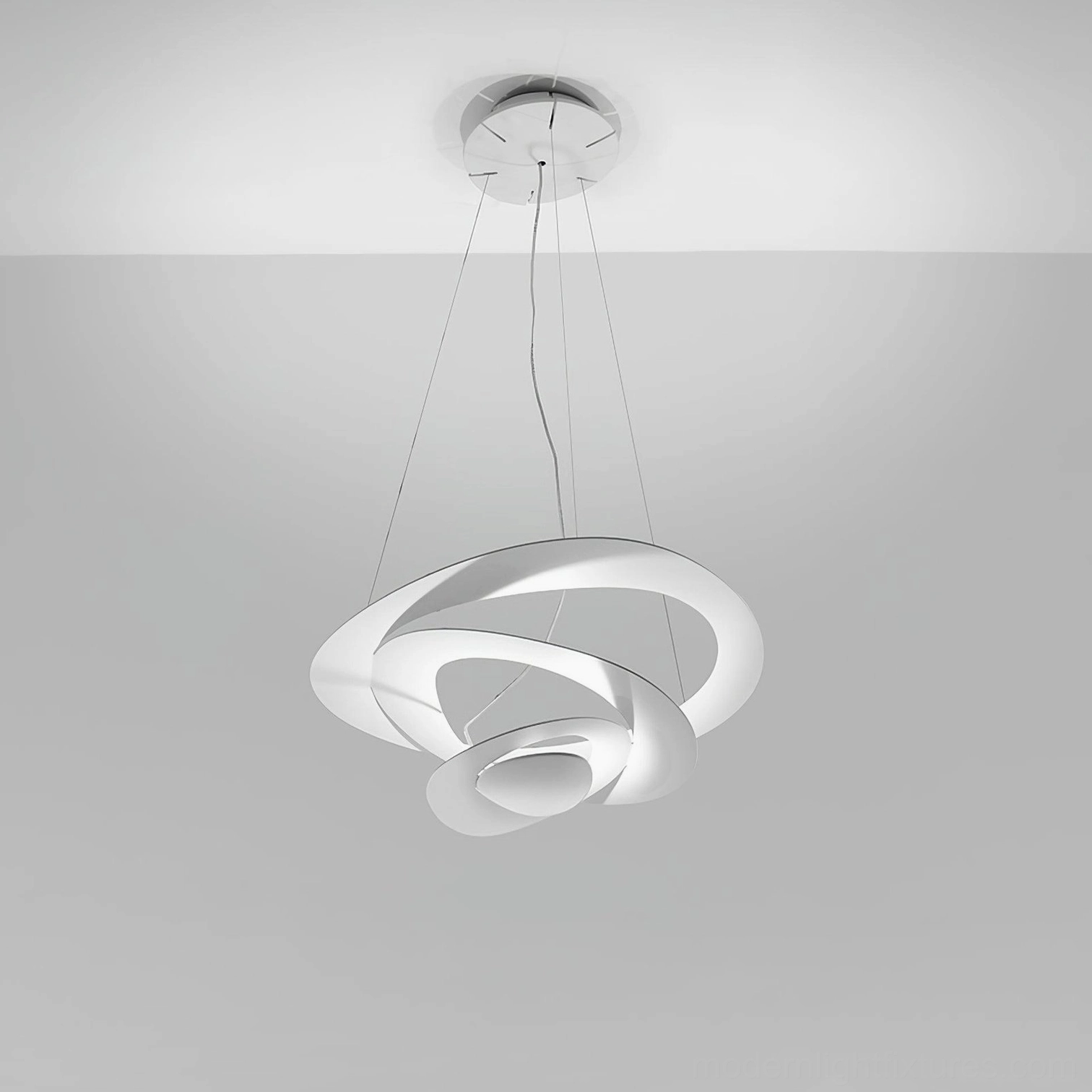 Spiral ring LED pendant suspended in loft space, minimalist design with integrated LED technology