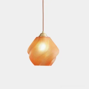 Spirvia hand-blown twisted glass pendant light in amber - front studio view showing swirled ribbed texture with brass hardware