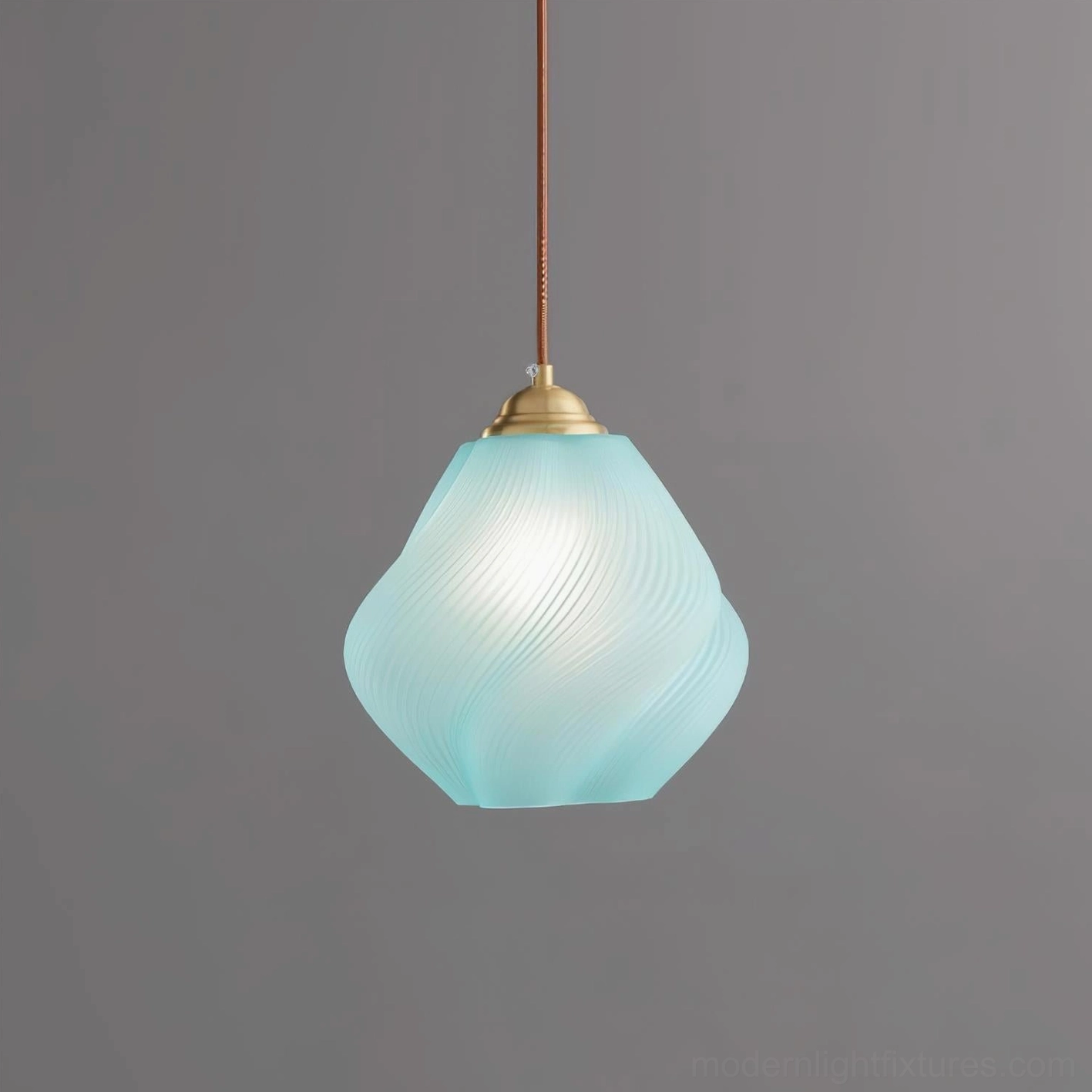 Spirvia blue hand-blown twisted glass pendant light - serene blue swirled frosted glass shade with brass fixture studio photography