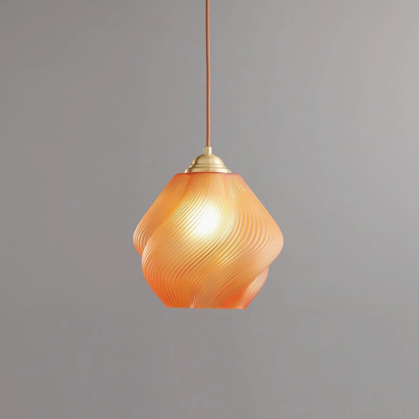 Spirvia twisted glass pendant lamp glowing from within - close-up shot on gray background highlighting swirled frosted glass and brass fixture