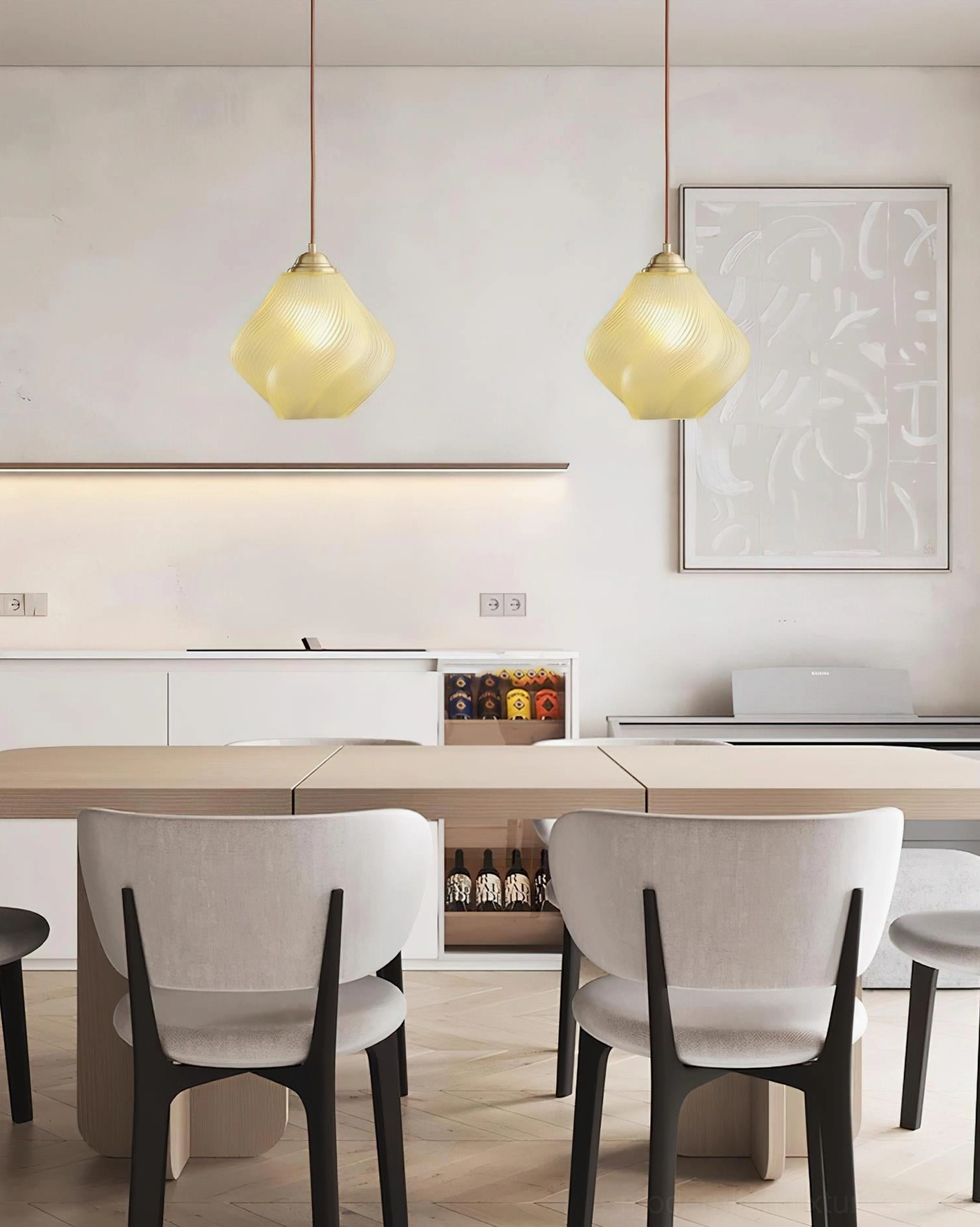 Pair of pale yellow Spirvia twisted pendant lights in contemporary dining room - installed above dining table with upholstered chairs