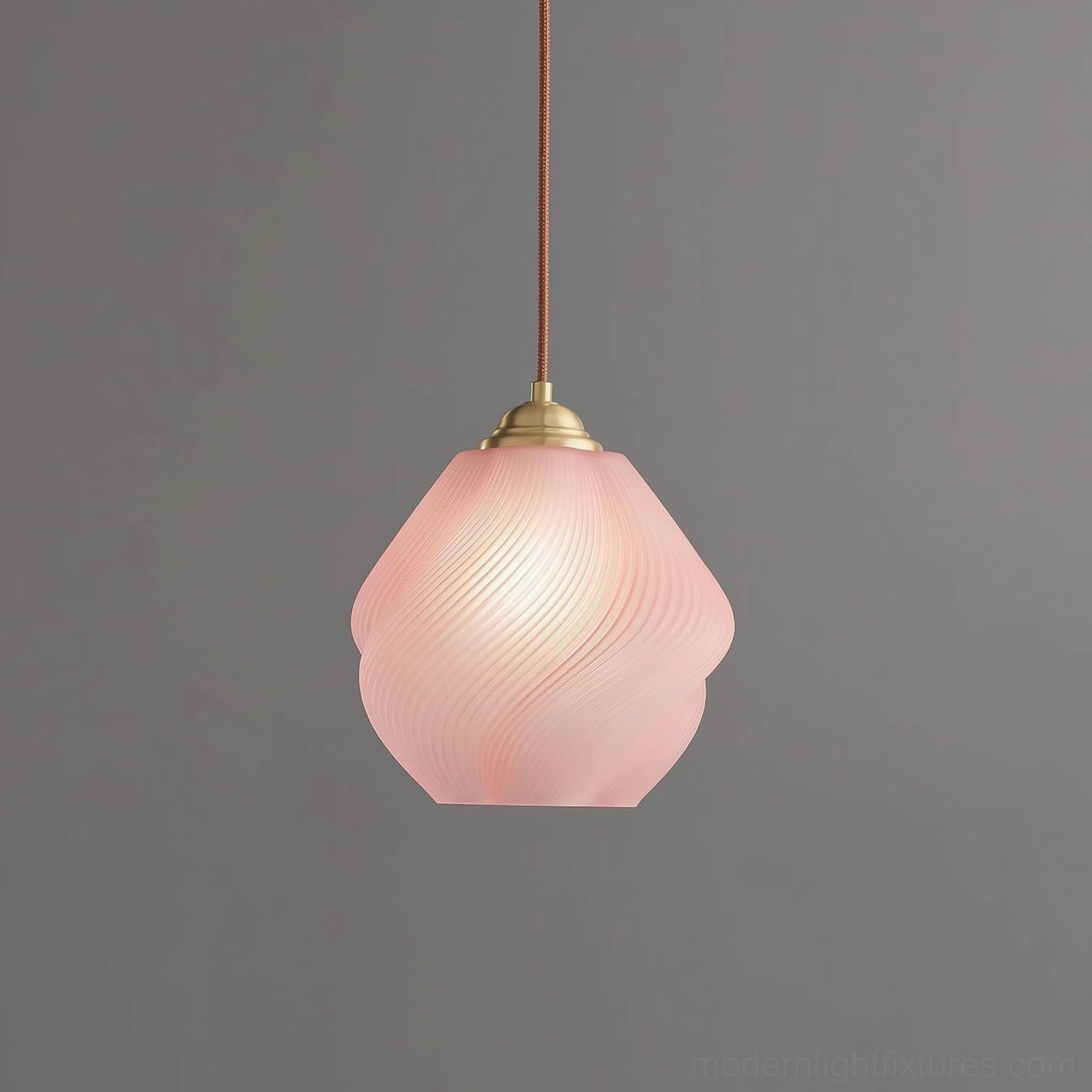 Spirvia blush pink hand-blown twisted glass pendant light - soft pink swirled frosted glass shade with brass hardware studio close-up