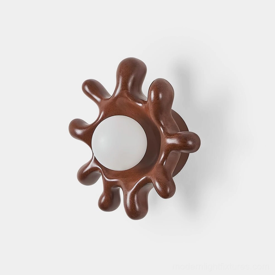 Splova organic wall sconce front view with irregular sun-shaped design in dark brown finish