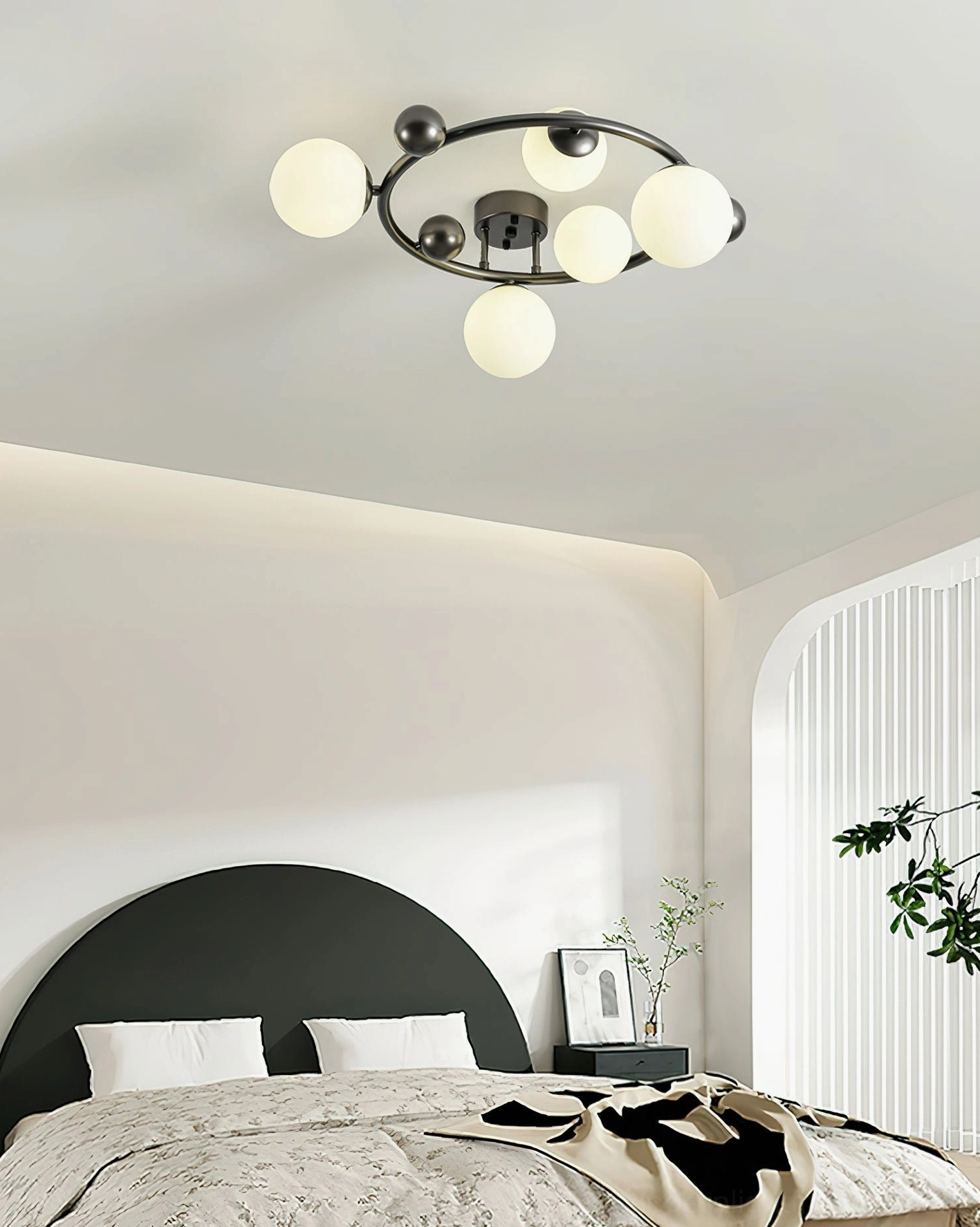 Black 5-globe sputnik ceiling light installed in modern master bedroom with arched window - warm ambient lighting