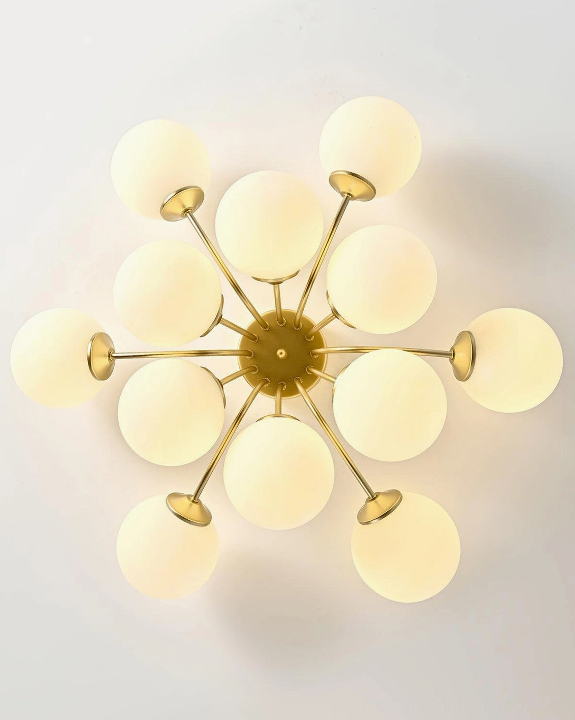 Overhead top-down view of starburst brass gold ceiling light with frosted glass globes radiating from center