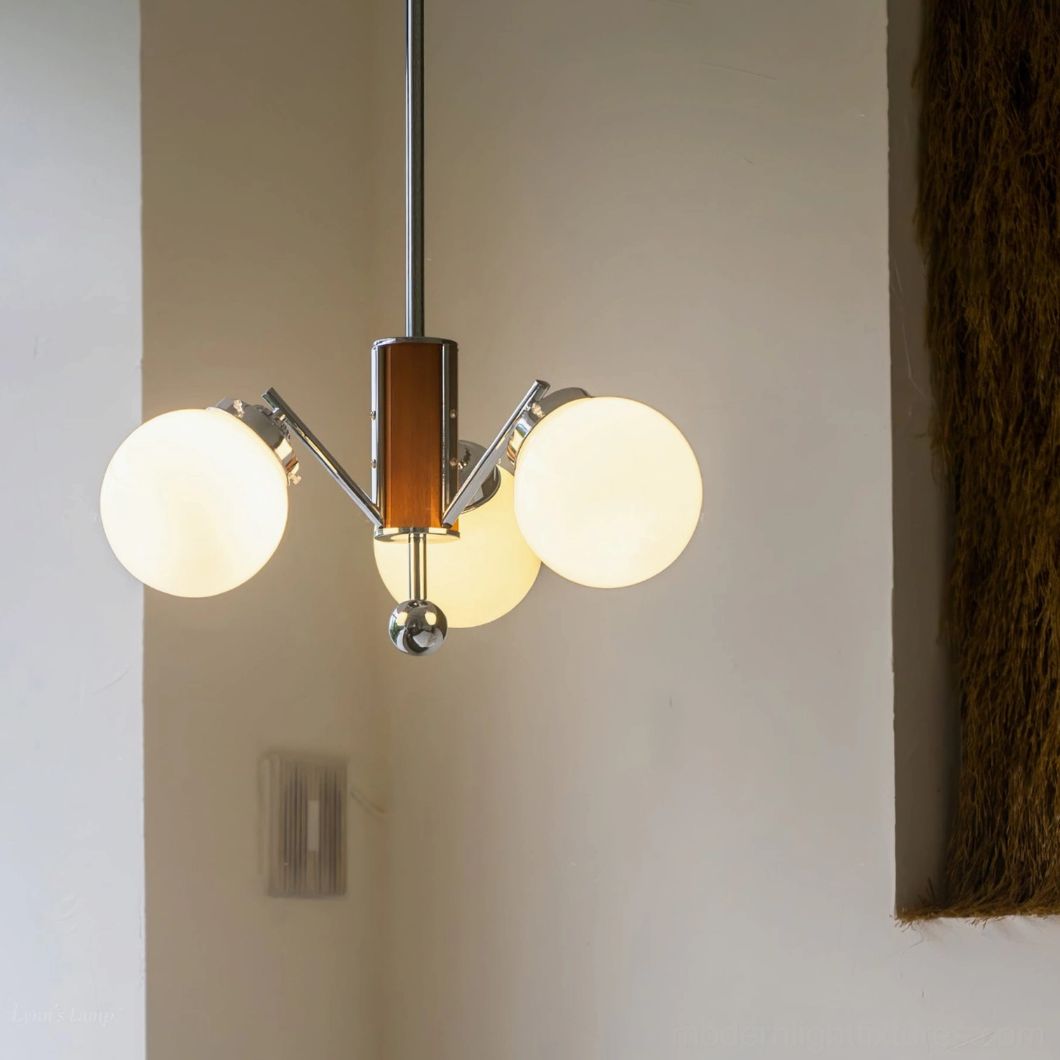 3-head sputnik chandelier with warm glowing light, mid-century modern interior, textured wall decor residential setting
