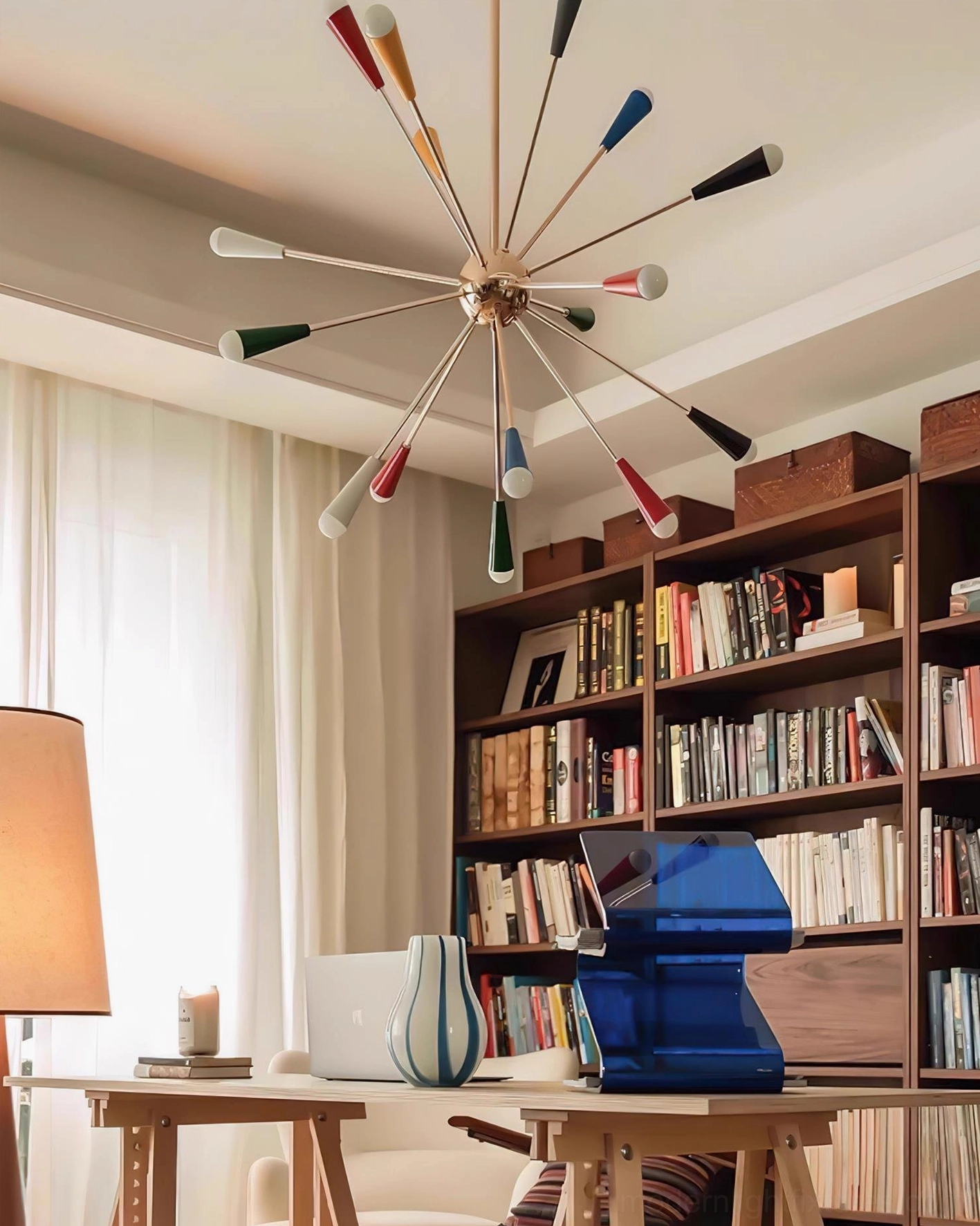 Sputnik starburst pendant light creating ambient glow with colorful cone shades in home interior