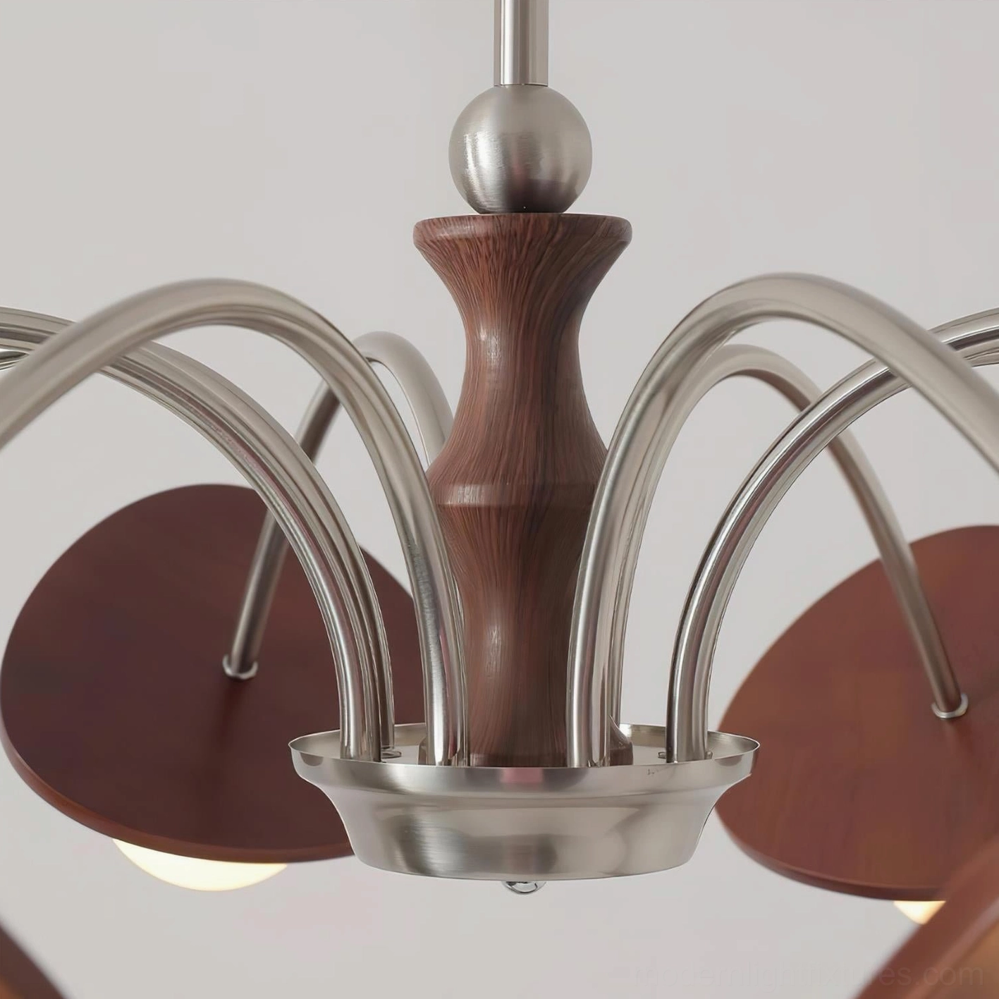Close-up detail view of brushed nickel metal arms, turned wooden center post, and walnut accent disc accents