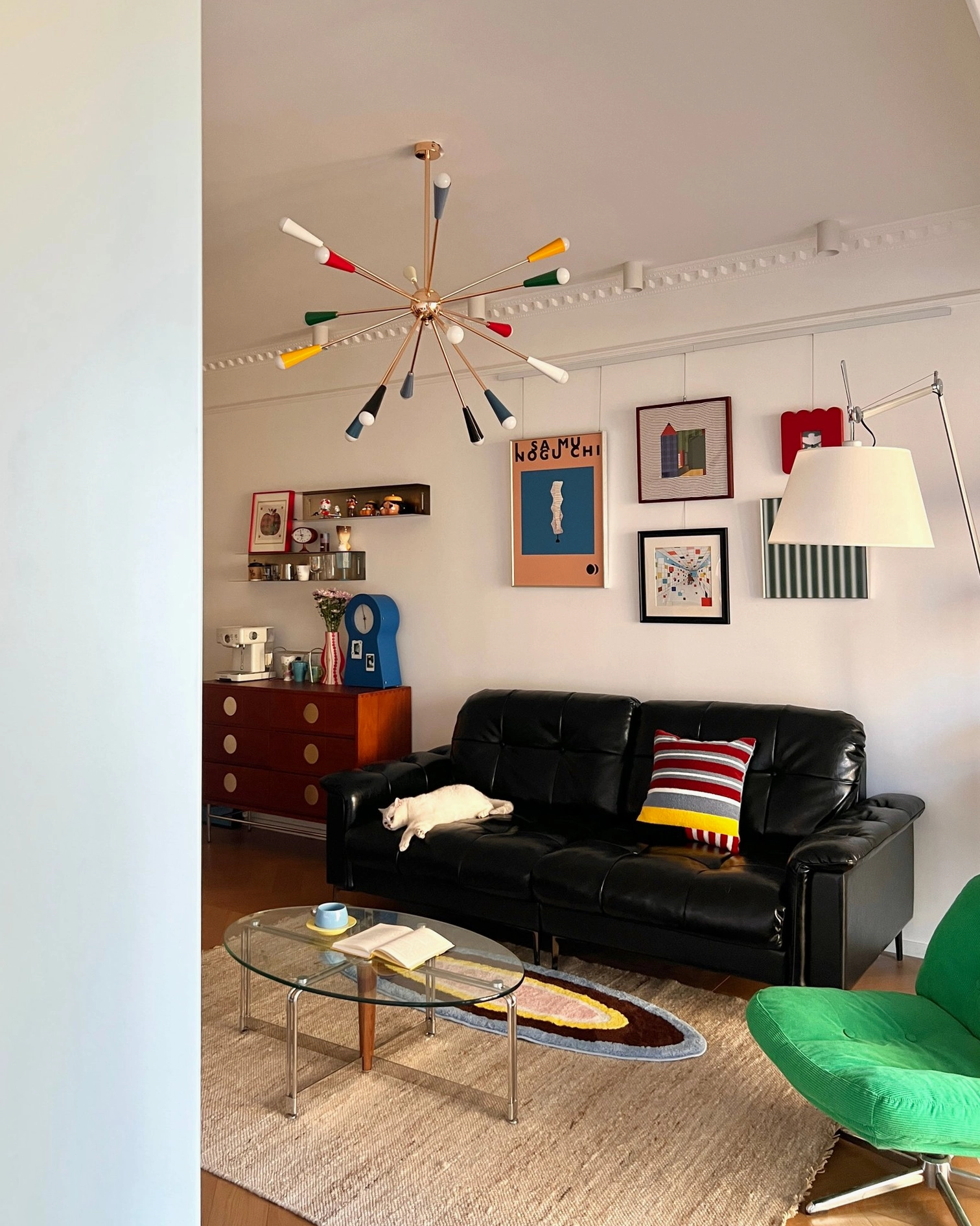 Sputnik burst chandelier distant ceiling view in retro residential living room with gold frame