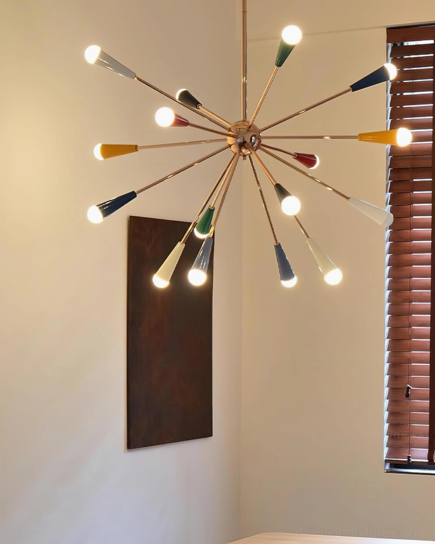 Sputnik starburst chandelier in eclectic bedroom with jewel-tone accents and vintage furnishings