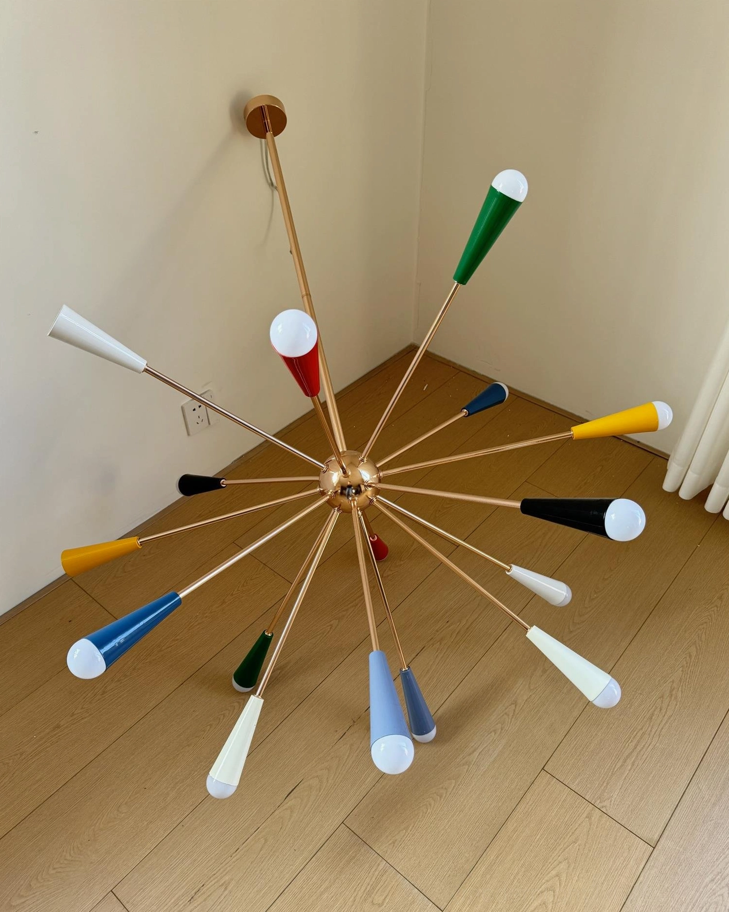 Sputnik starburst chandelier ground-level view in residential corner with wooden floor