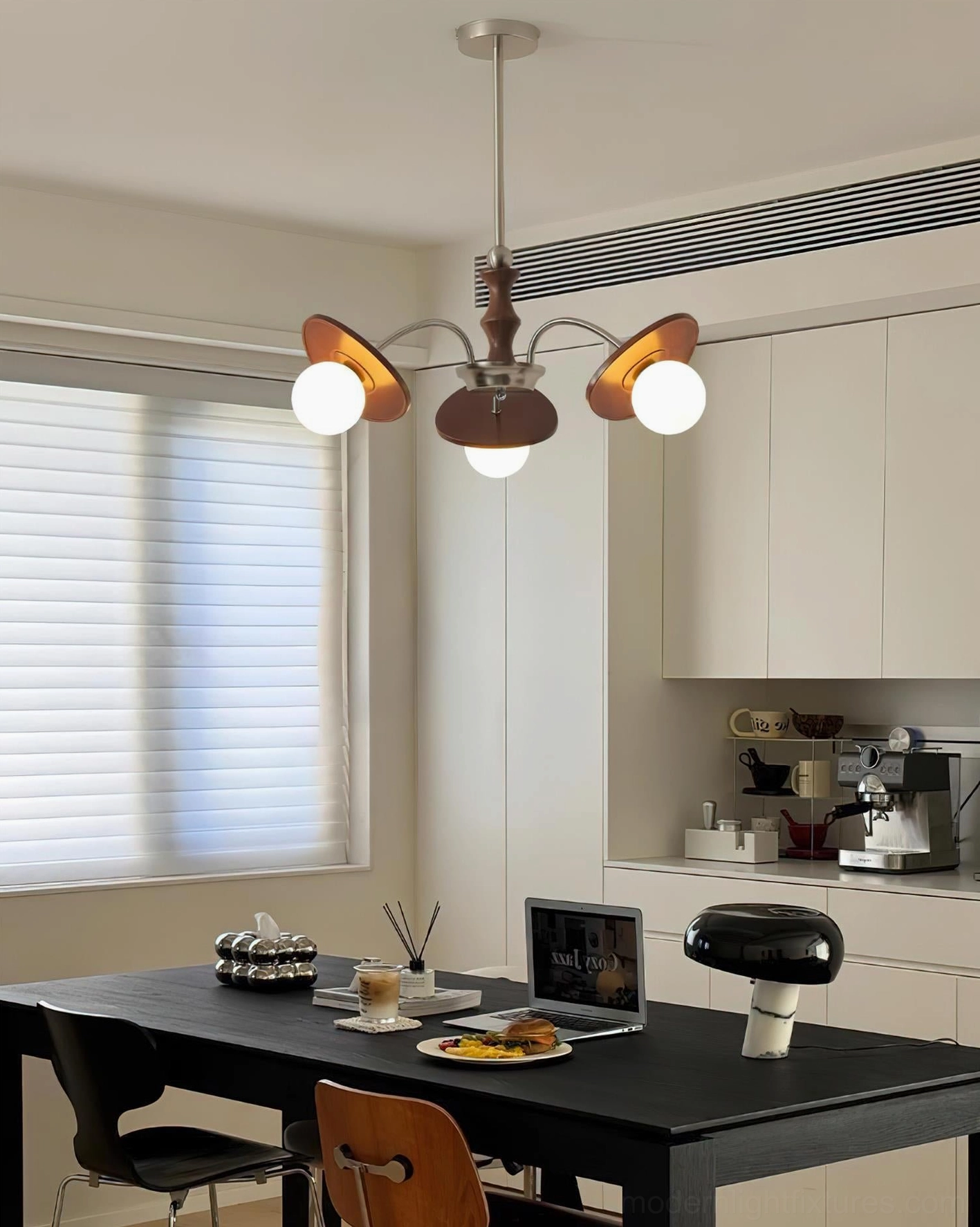 Illuminated mid-century modern sputnik chandelier as dining room focal point with warm light and furnished table setup