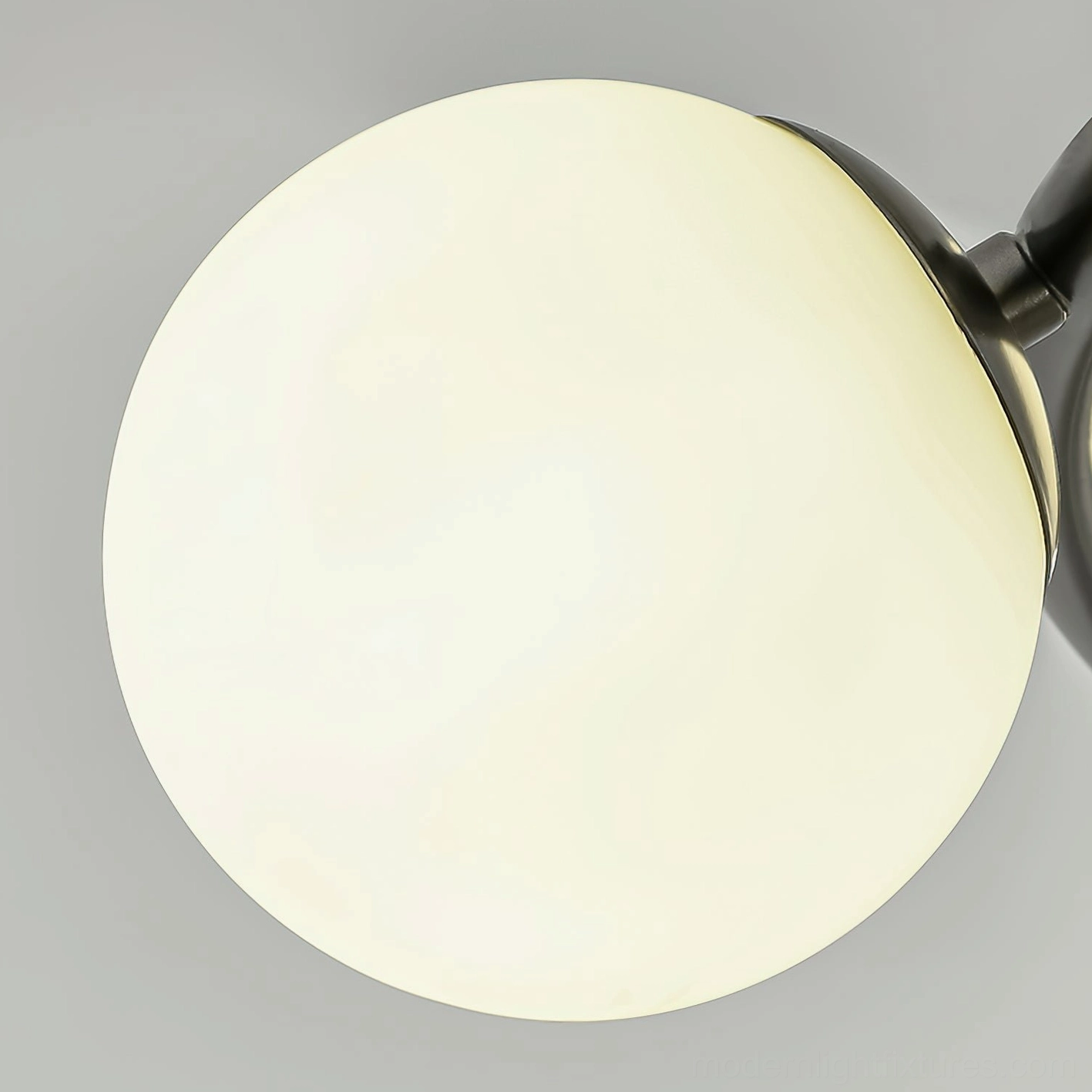 Sputnik-style modern ceiling light fixture in black - close-up showing glass globe construction and metal framework