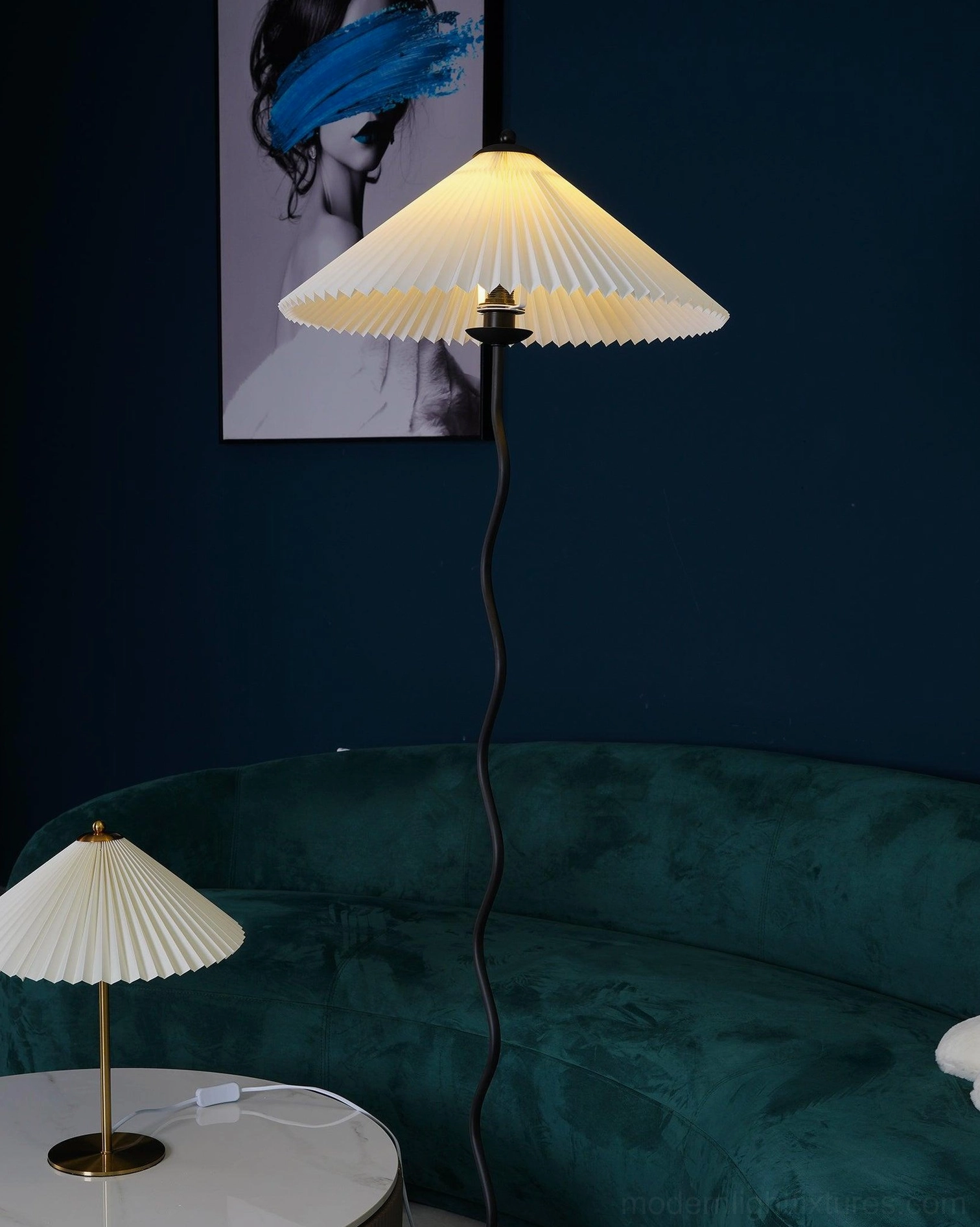 Sculptural squiggle lamp with gold metal base next to matching pleated table lamp - coordinated modern lighting set design
