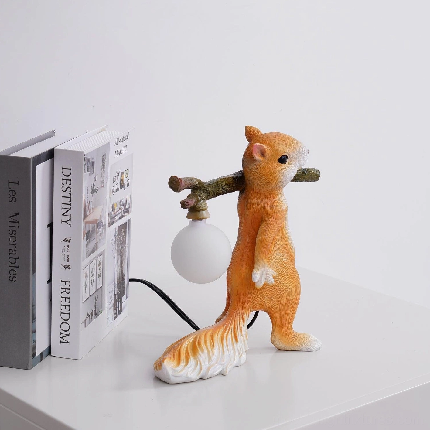 Orange and white squirrel resin table lamp, sculptural form showing playful wildlife-inspired design