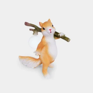 Whimsical orange and white squirrel resin table lamp with frosted bulb, front three-quarter view on neutral background