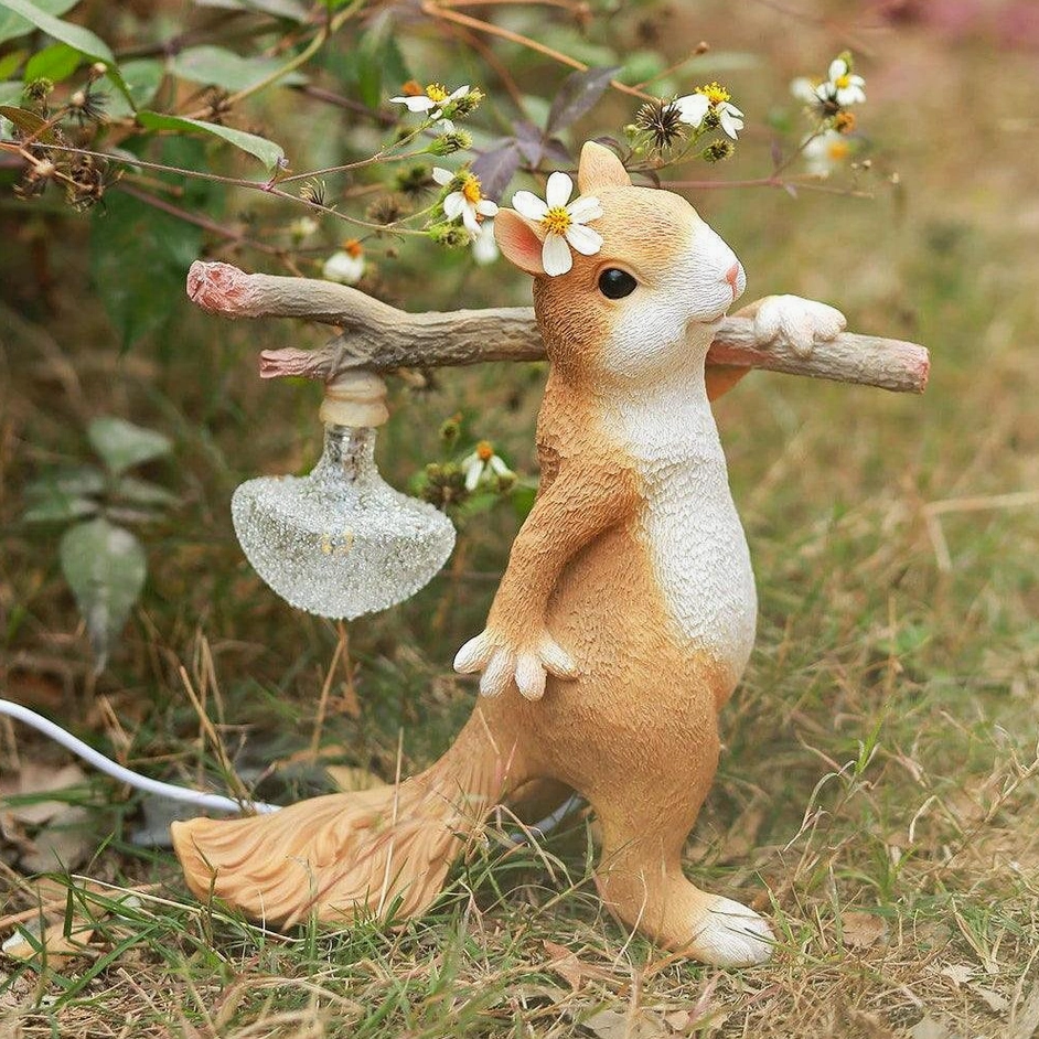 Squirrel resin lamp in outdoor garden setting with glitter glass bulb, natural woodland styling